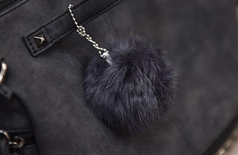 Close-up of Rustic Charm Leather Shoulder Bag with a fluffy keychain detail, highlighting the stylish cowgirl handbag design.