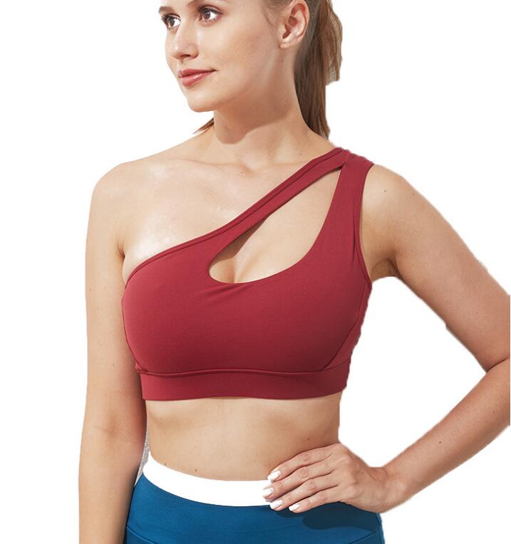 Woman wearing Mermaid Curve Sports Bra with one-shoulder cut, ideal for workouts and yoga.