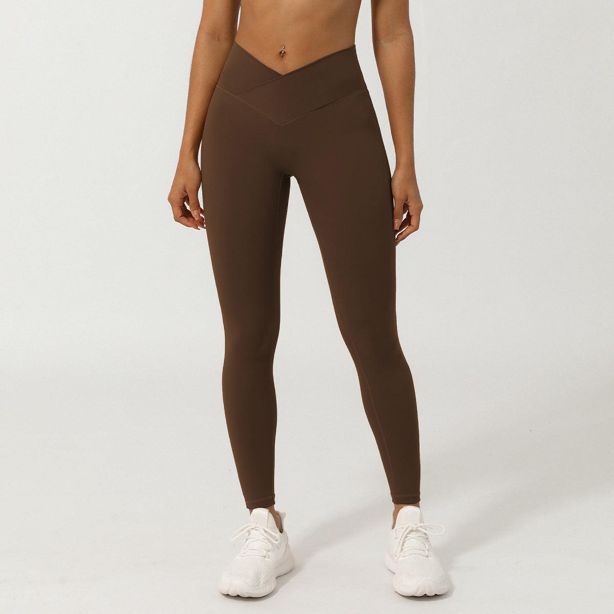 Woman wearing V-Shaped High-Waisted Yoga Pants | Skinny Fit Workout Pants for Fitness & Yoga in brown color with sneakers.
