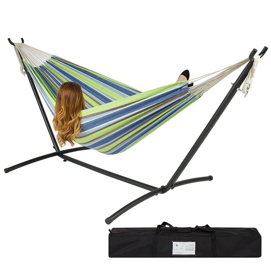 Portable Blue Green Stripe Cotton Hammock with Metal Stand and Carry Case setup outdoors with a person relaxing