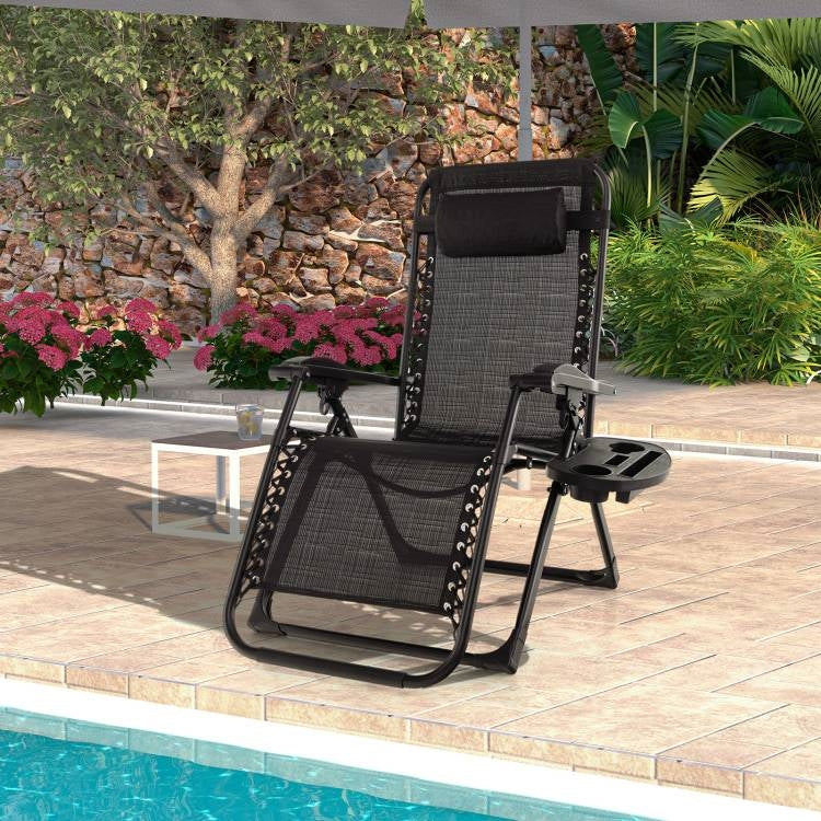 Black Zero Gravity Adjustable Lounge Chair Removable Cushion Cup Holder Tray by the poolside.