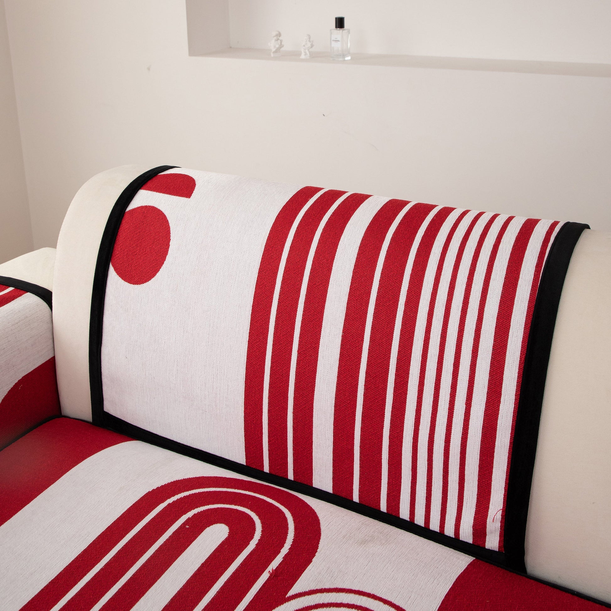 Modern Geometric Sofa Cover - Thick Woven, Pet Friendly, Stylish Couch Protector in red and white, on a modern couch.