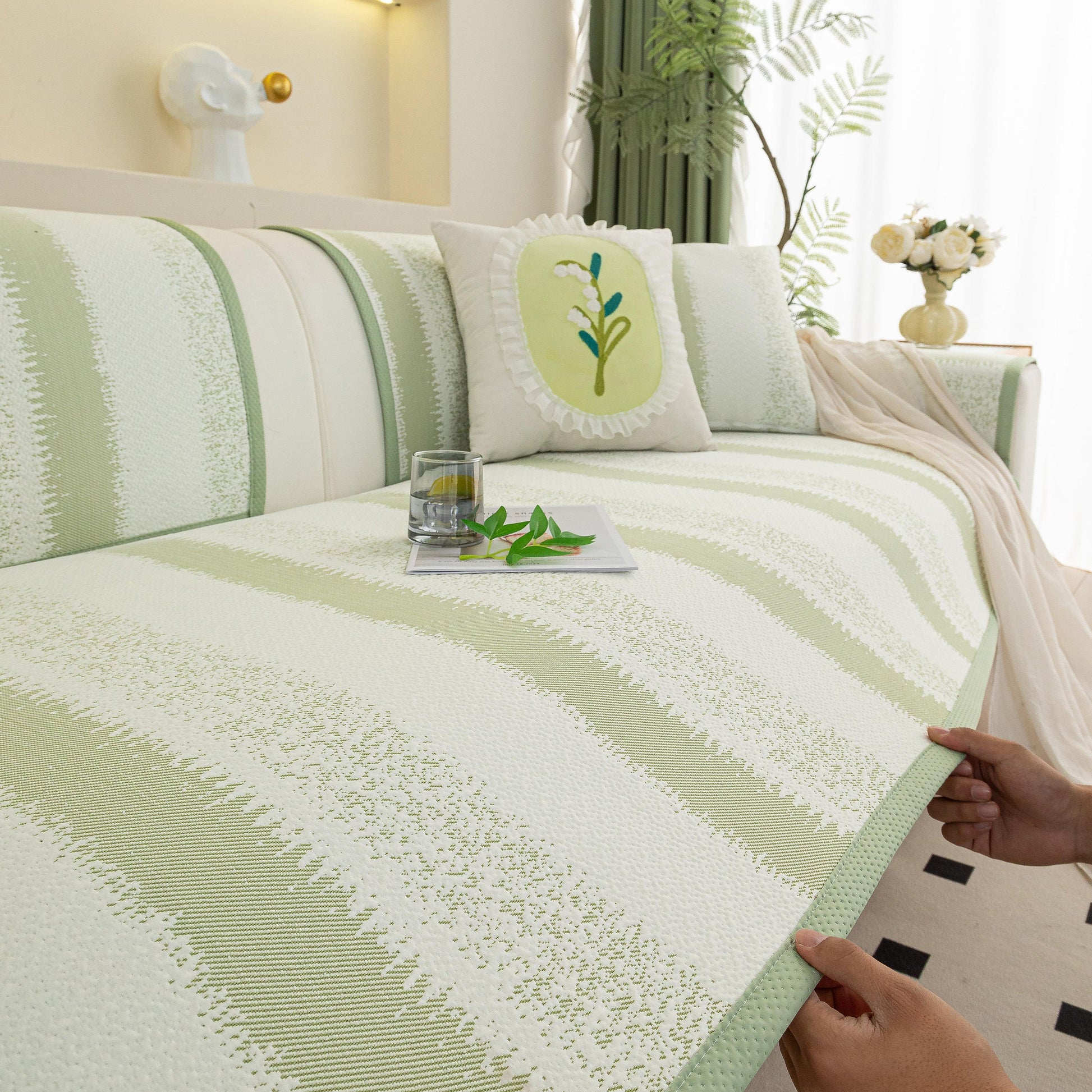 Striped Non-Slip Cooling Couch Cover, Summer Couch Pads for Seat Back Armrest set on a sofa with plant accents.