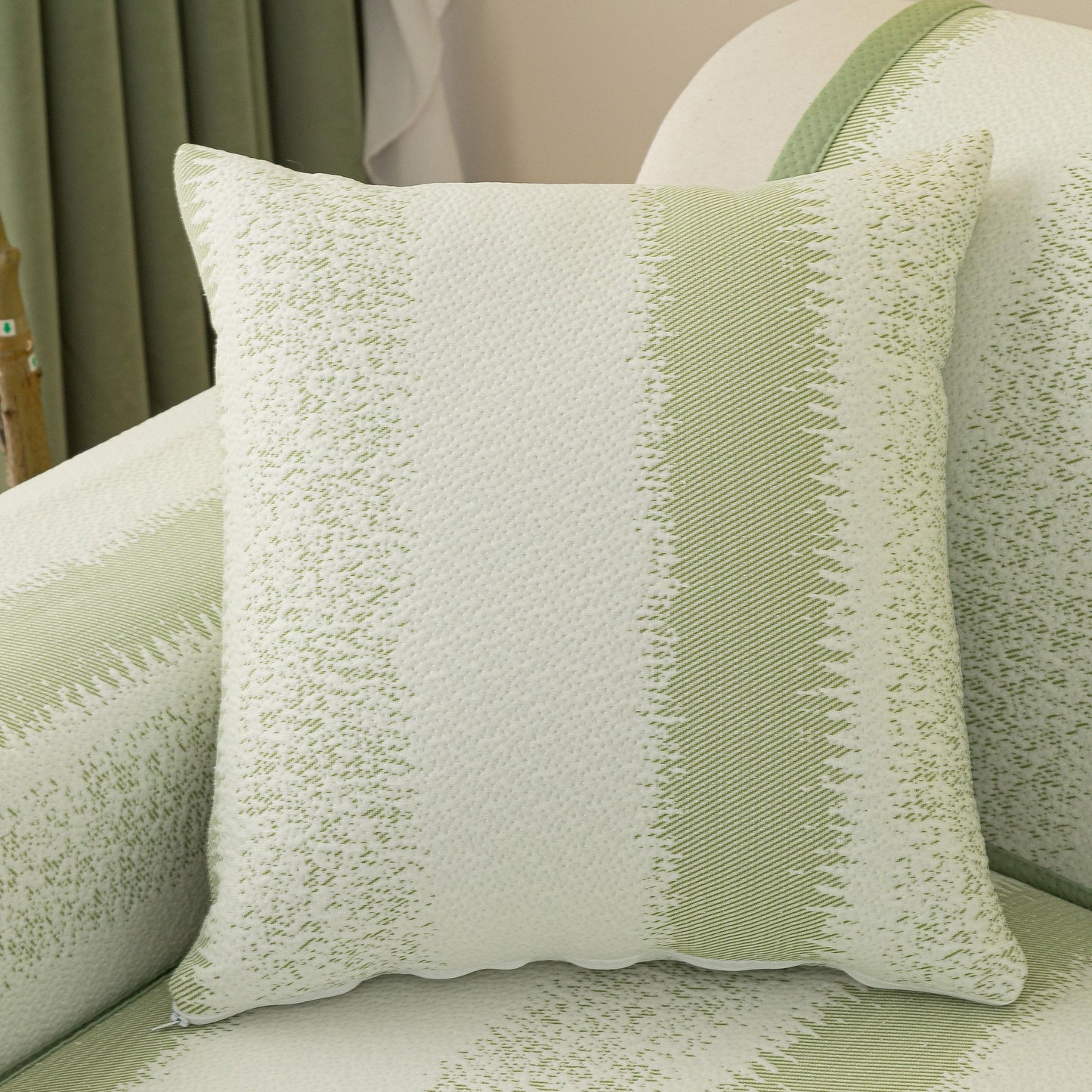 Green and white striped pillow on a couch with Striped Non-Slip Cooling Couch Cover, Summer Couch Pads for Seat Back Armrest.