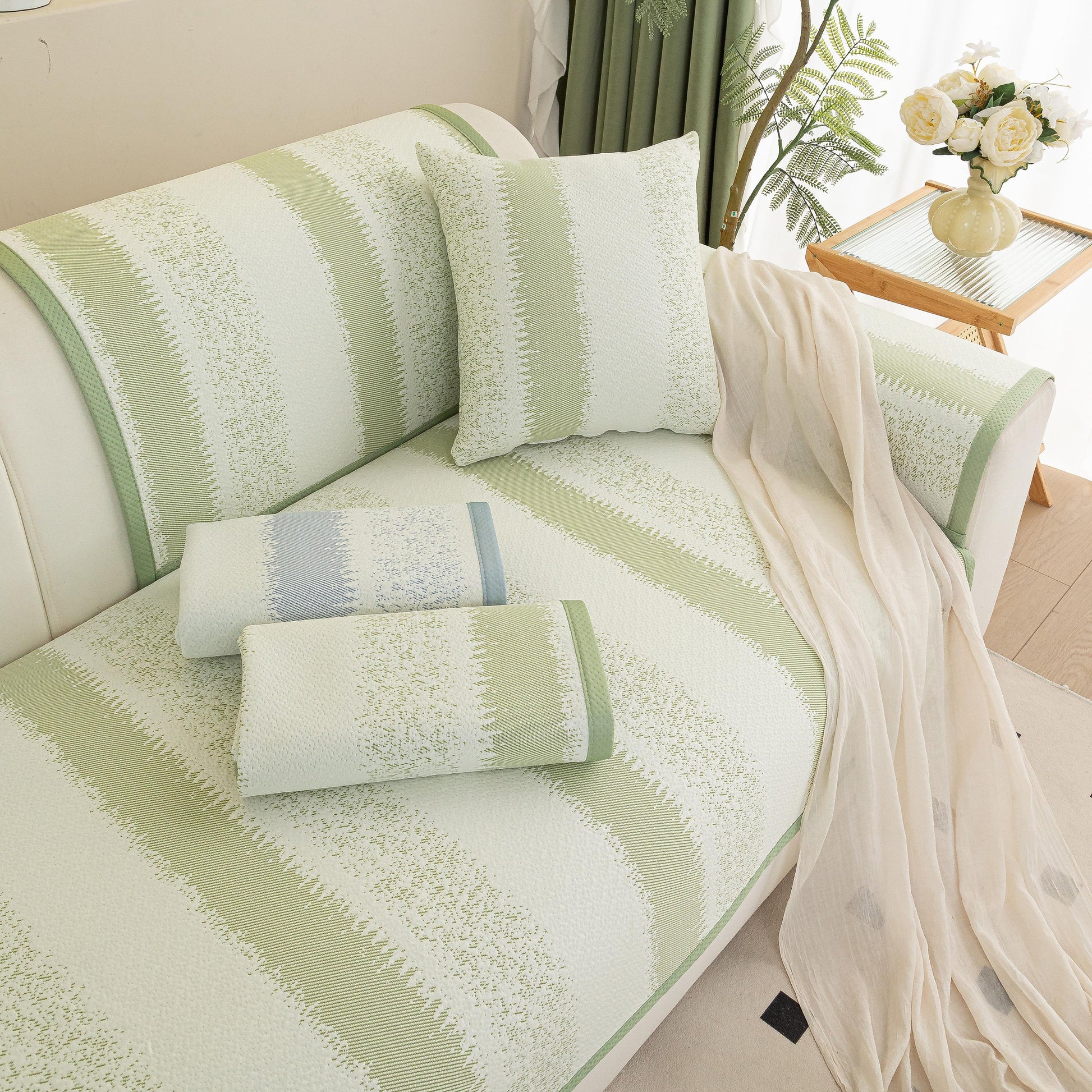 Striped Non-Slip Cooling Couch Cover, Summer Couch Pads for Seat Back Armrest in light green on a sofa with pillow and draped fabric.