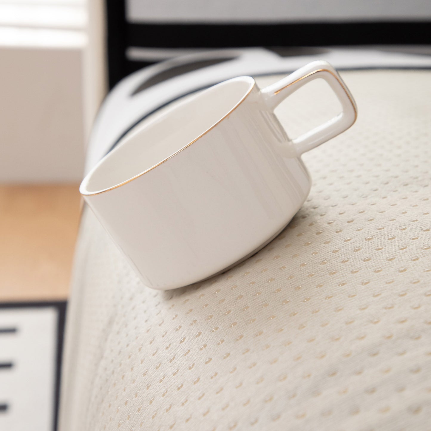 White cup on Modern Geometric Sofa Cover - Thick Woven, Pet Friendly, Stylish Couch Protector with anti-slip backing.