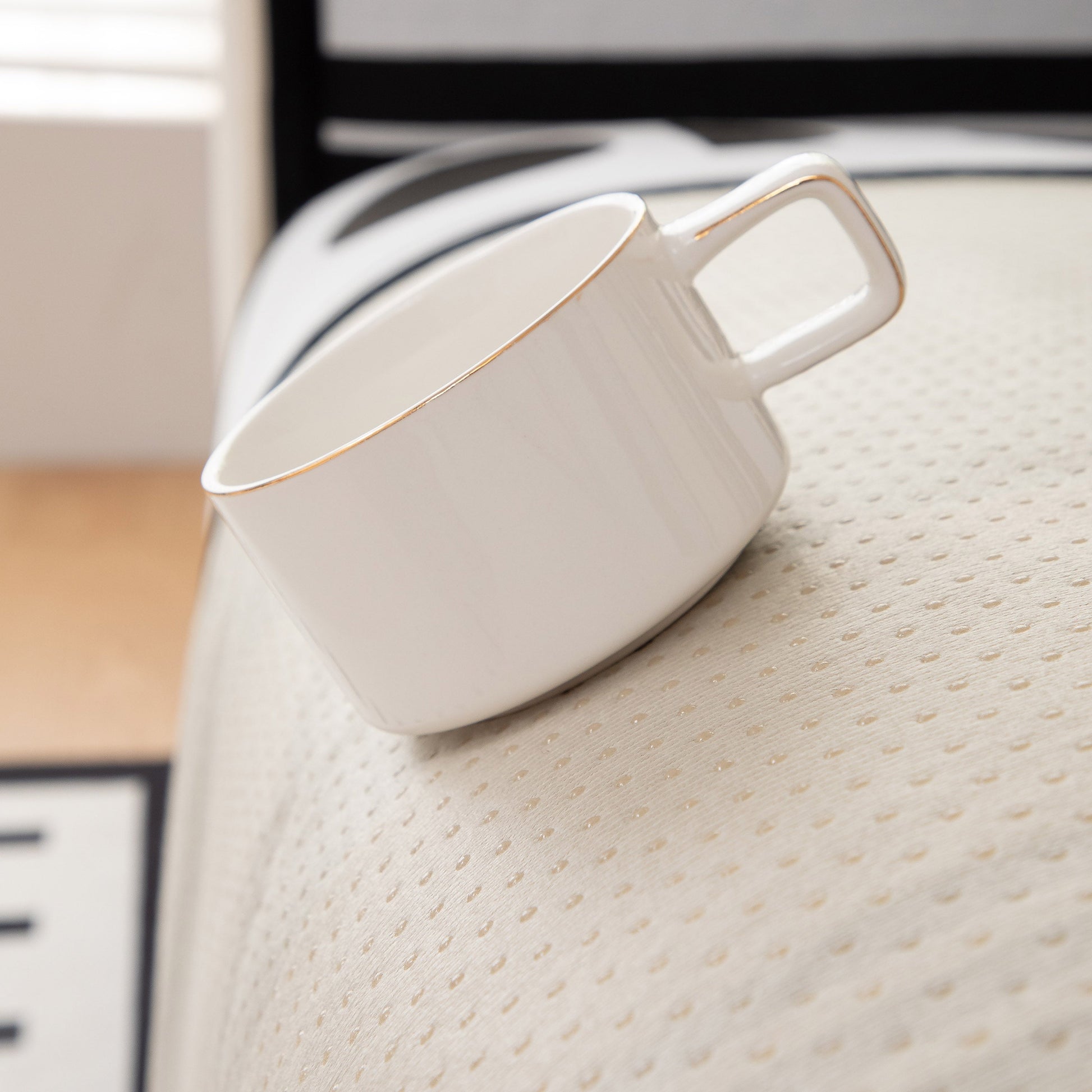 White cup on Modern Geometric Sofa Cover - Thick Woven, Pet Friendly, Stylish Couch Protector with anti-slip backing.