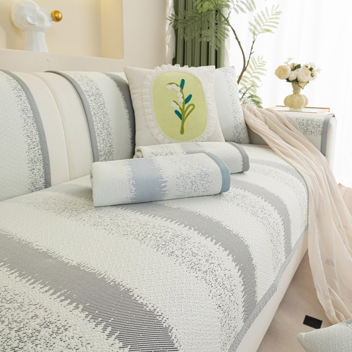 Striped Non-Slip Cooling Couch Cover, Summer Couch Pads for Seat Back Armrest on a stylishly decorated sofa.