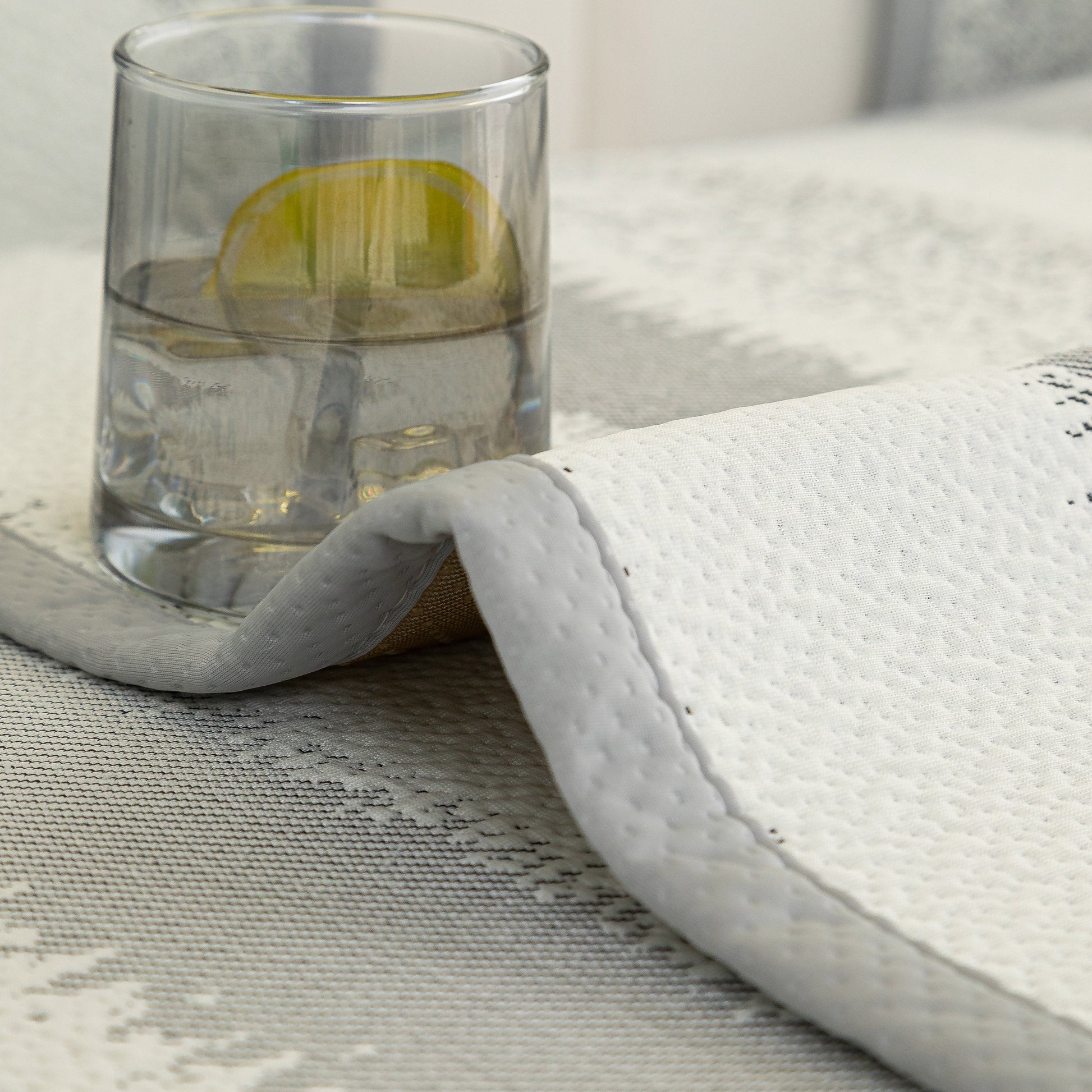 Striped Non-Slip Cooling Couch Cover, Summer Couch Pads for Seat Back Armrest with water glass demonstrating non-slip feature