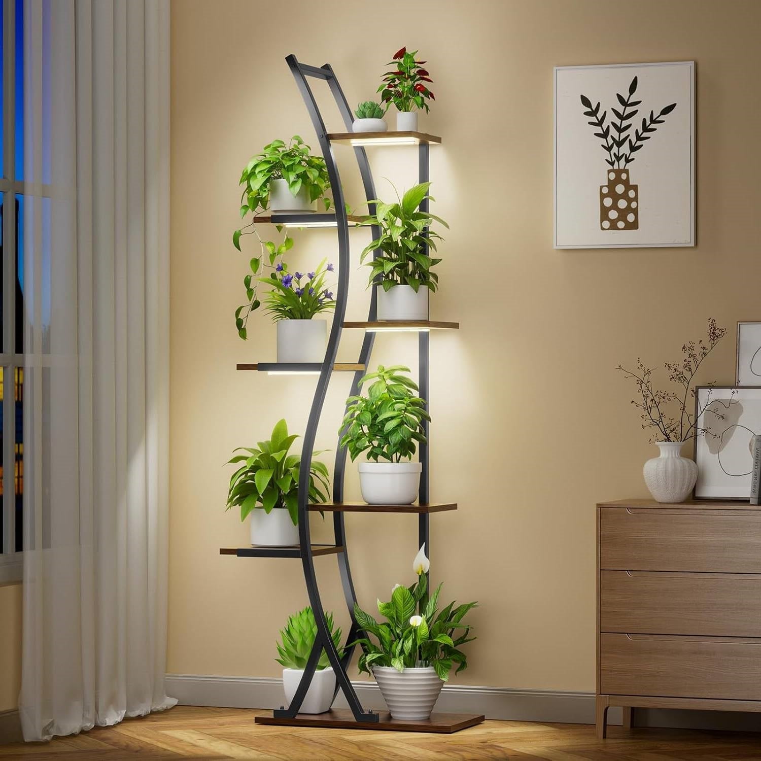 63-inch Tall Modern 6-Shelf Indoor Plant Stand Shelving Unit with grow lights displayed in a living room with various potted plants.