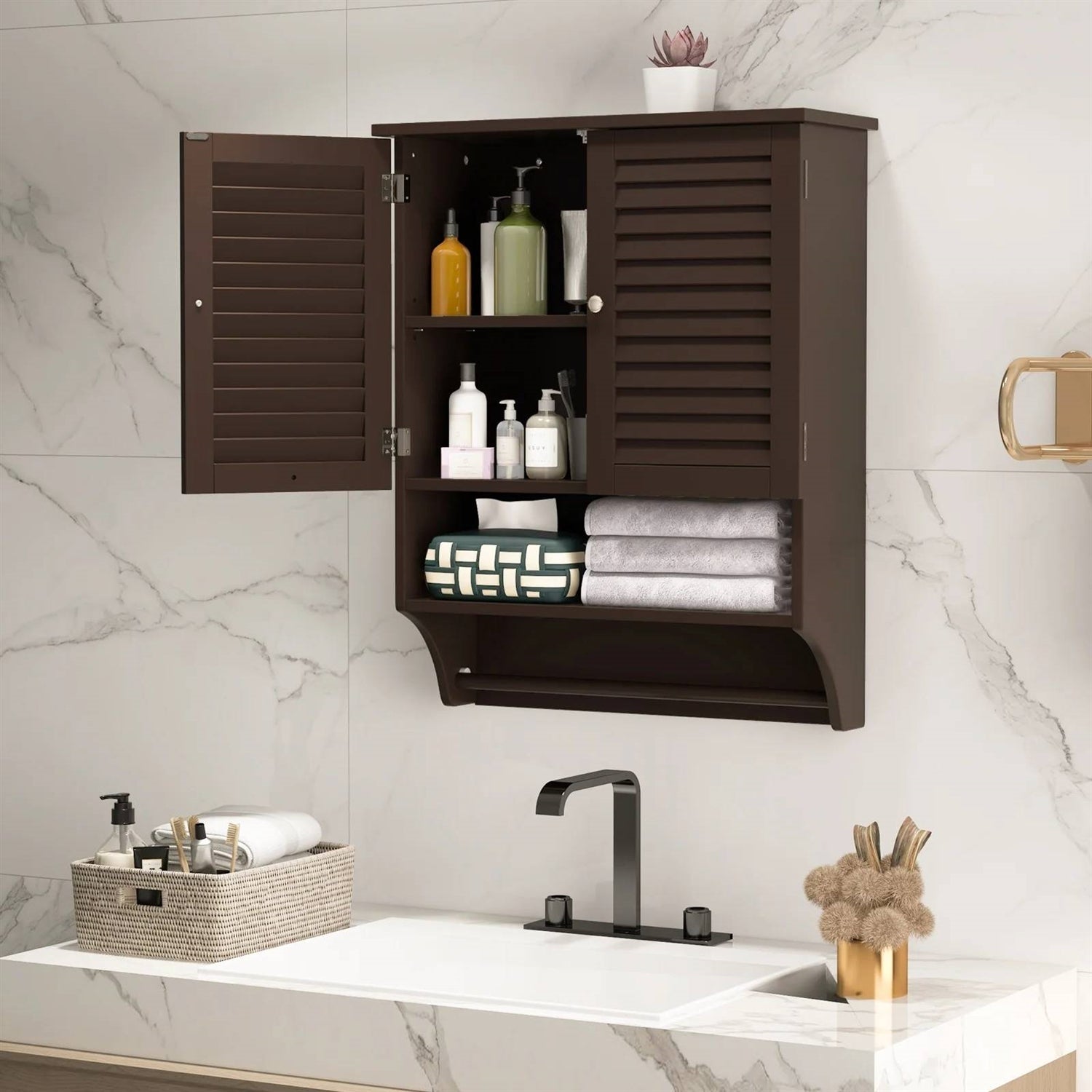 Brown Wall-Mounted Bathroom Medicine Cabinet with Louver Doors and Towel Bar above a bathroom sink with towels and toiletries.