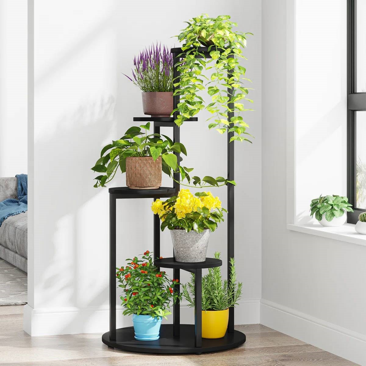 5-Tier Indoor Plant Stand with Black Metal Frame and Brown Wood Finish Shelves holding multiple plants in a sunny room corner.