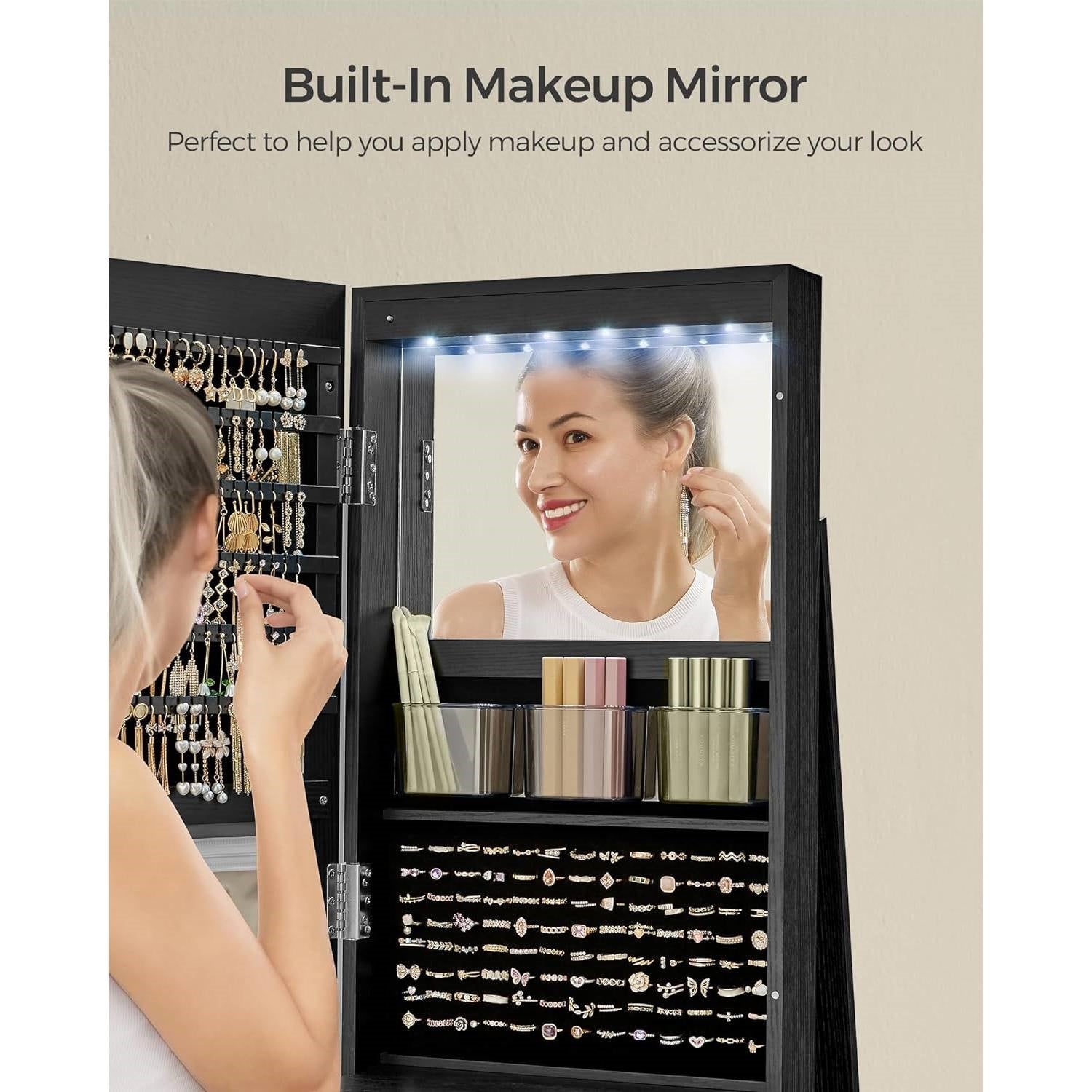 Woman using Black Wood Jewelry Cabinet Armoire Organizer Freestanding Rotating Mirror with built-in makeup mirror and earring storage.