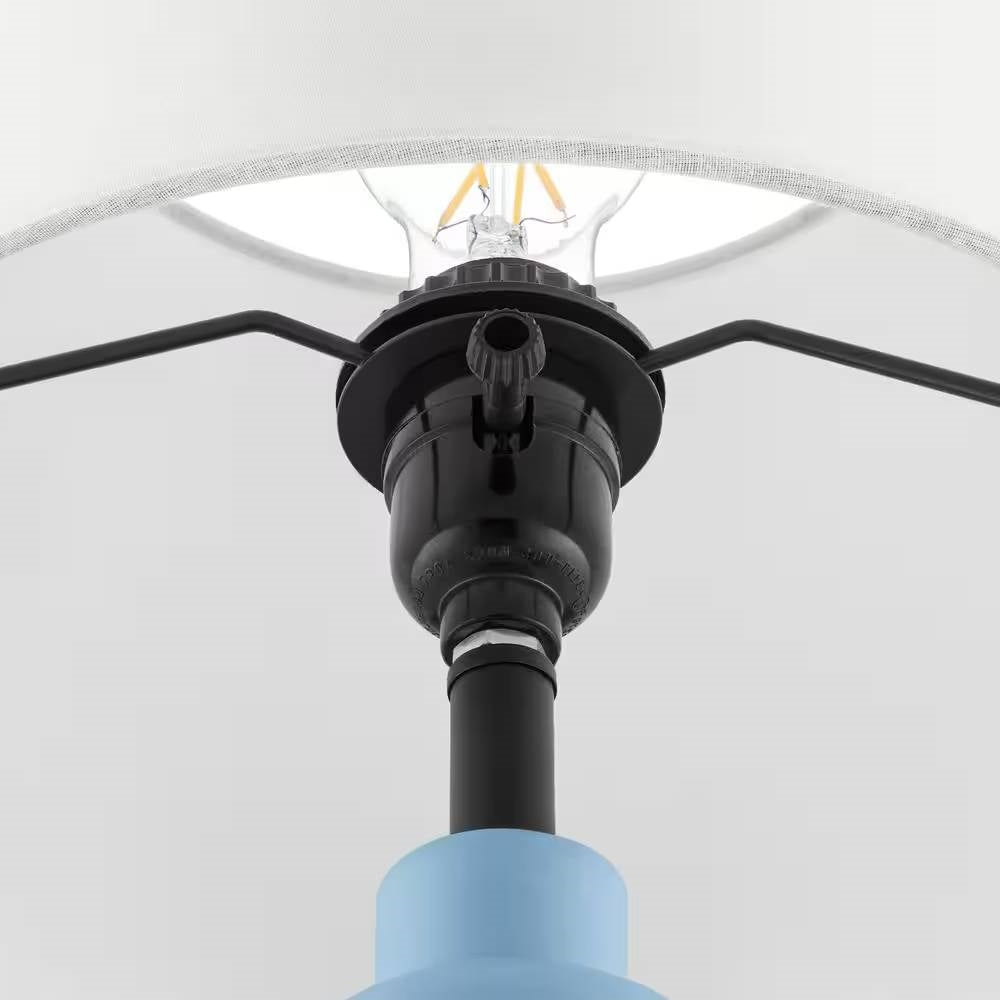 Close-up of Small Blue Desk Light Table Lamp with White Fabric Shade for Bedside Nightstand focusing on the light socket and bulb holder.