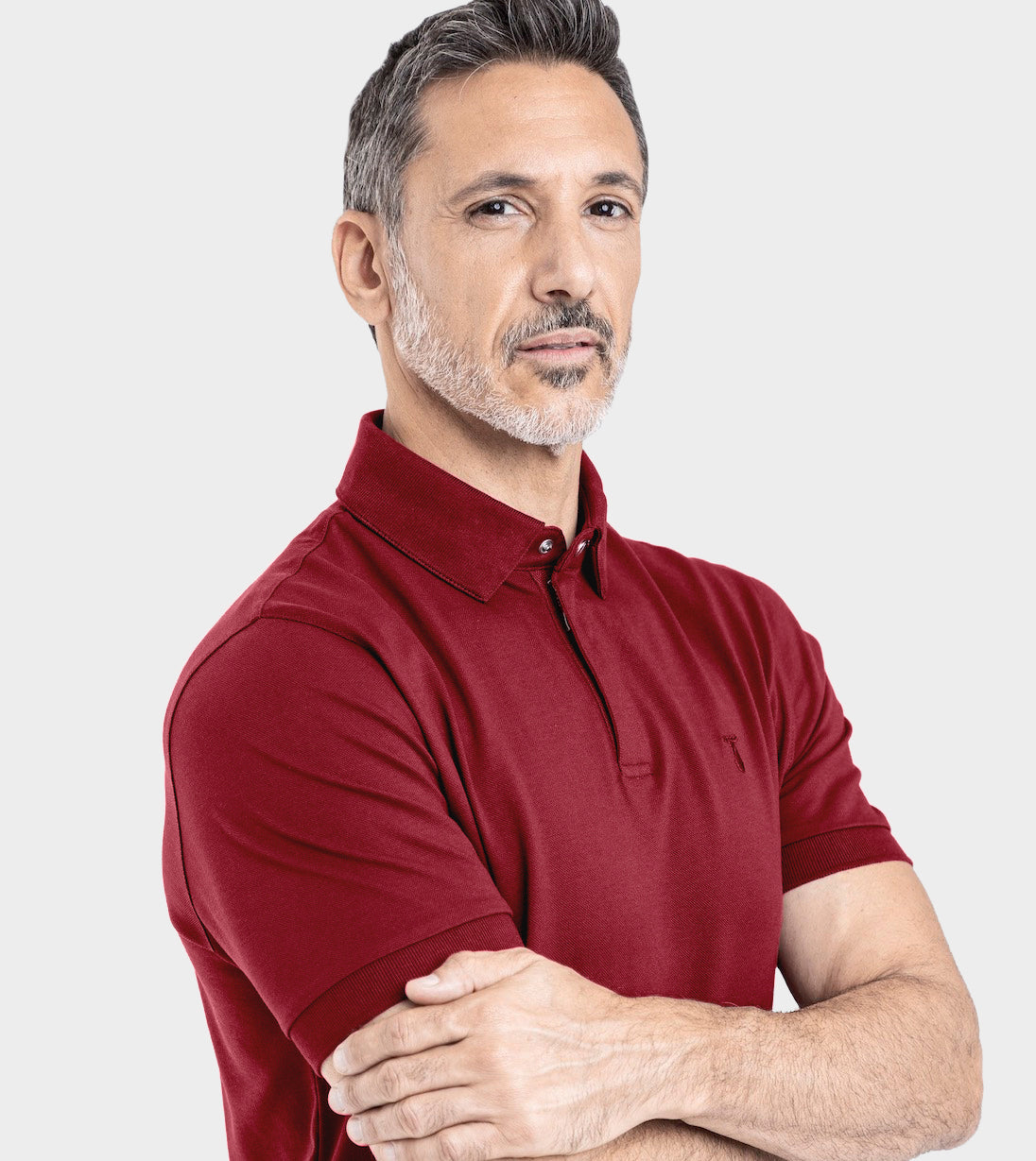 Man wearing Baobab Short Sleeve Perfect Polo in red with StaySharp™ Collar and tailored fit, showcasing modern style and innovation.