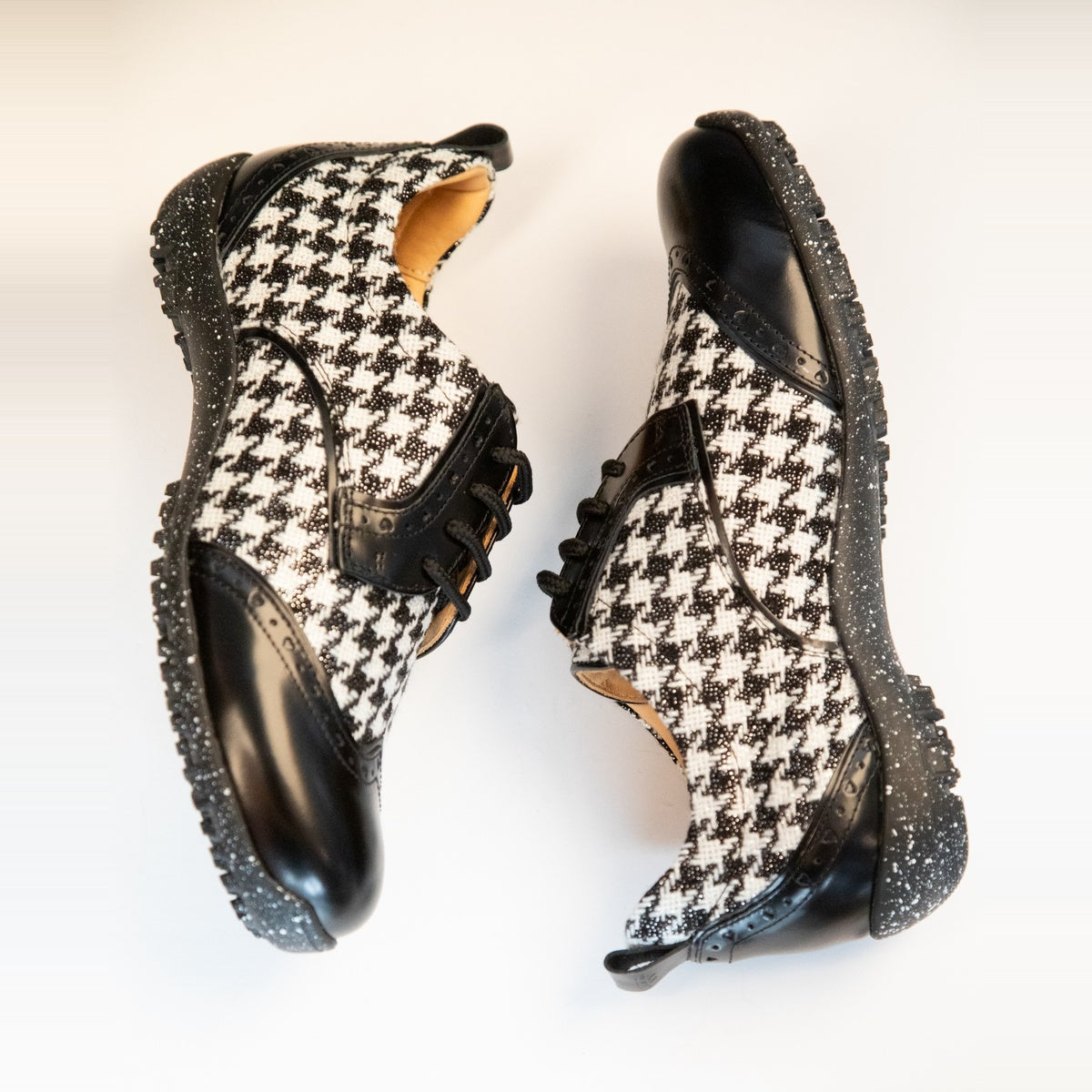 WesTees Javi shoes with black and white houndstooth pattern and black wingtip toe, engineered for comfort and durability.