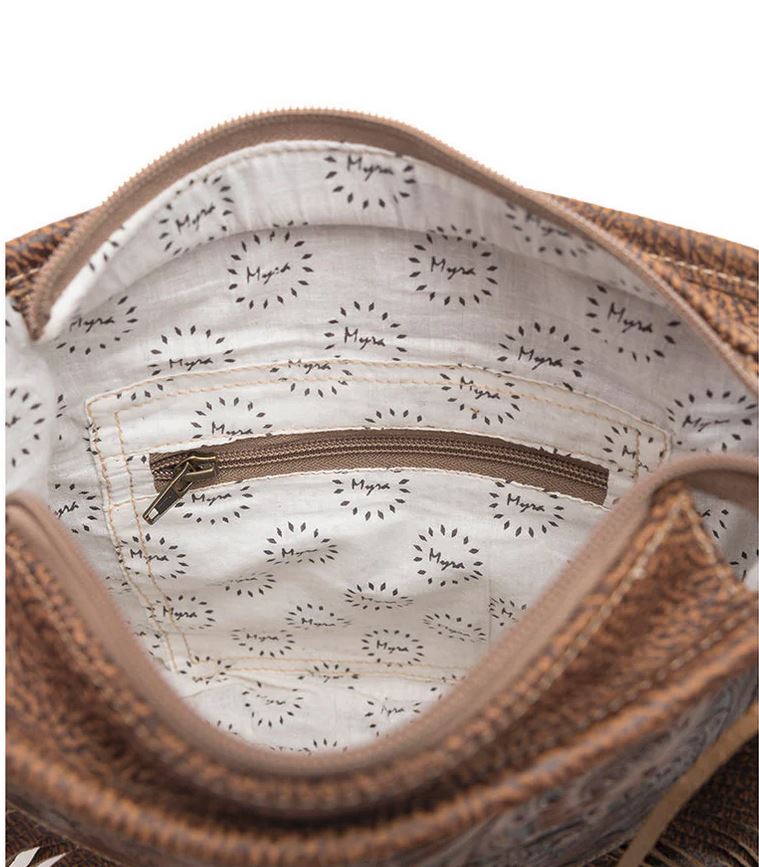 Interior view of hand tooled fringe bag showing spacious zipper pocket and patterned lining for carrying essentials.