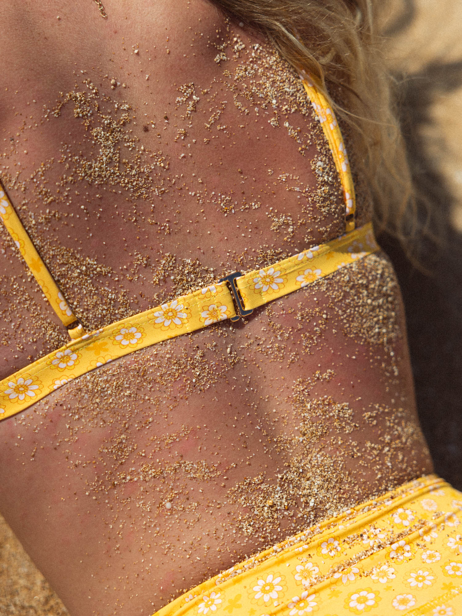 bindi top - coolangatta with adjustable straps and soft fabric, perfect for beach days, shown on sandy back.