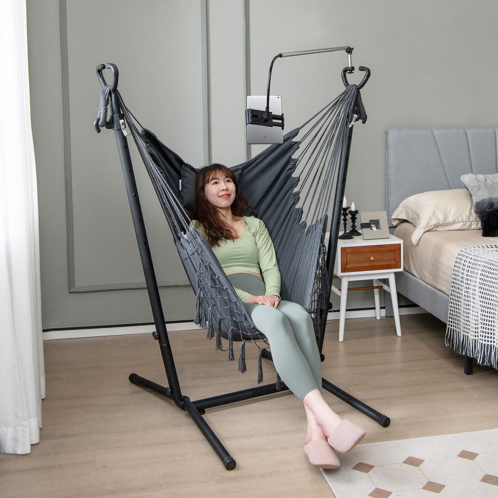 Height Adjustable Hammock Chair with Phone Holder and Side Pocket-Gray in a cozy bedroom setup with a woman sitting comfortably.