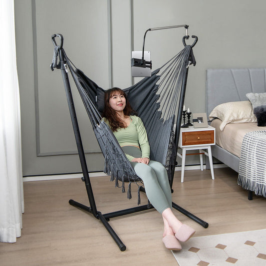 Height Adjustable Hammock Chair with Phone Holder and Side Pocket-Gray in a cozy bedroom setup with a woman sitting comfortably.