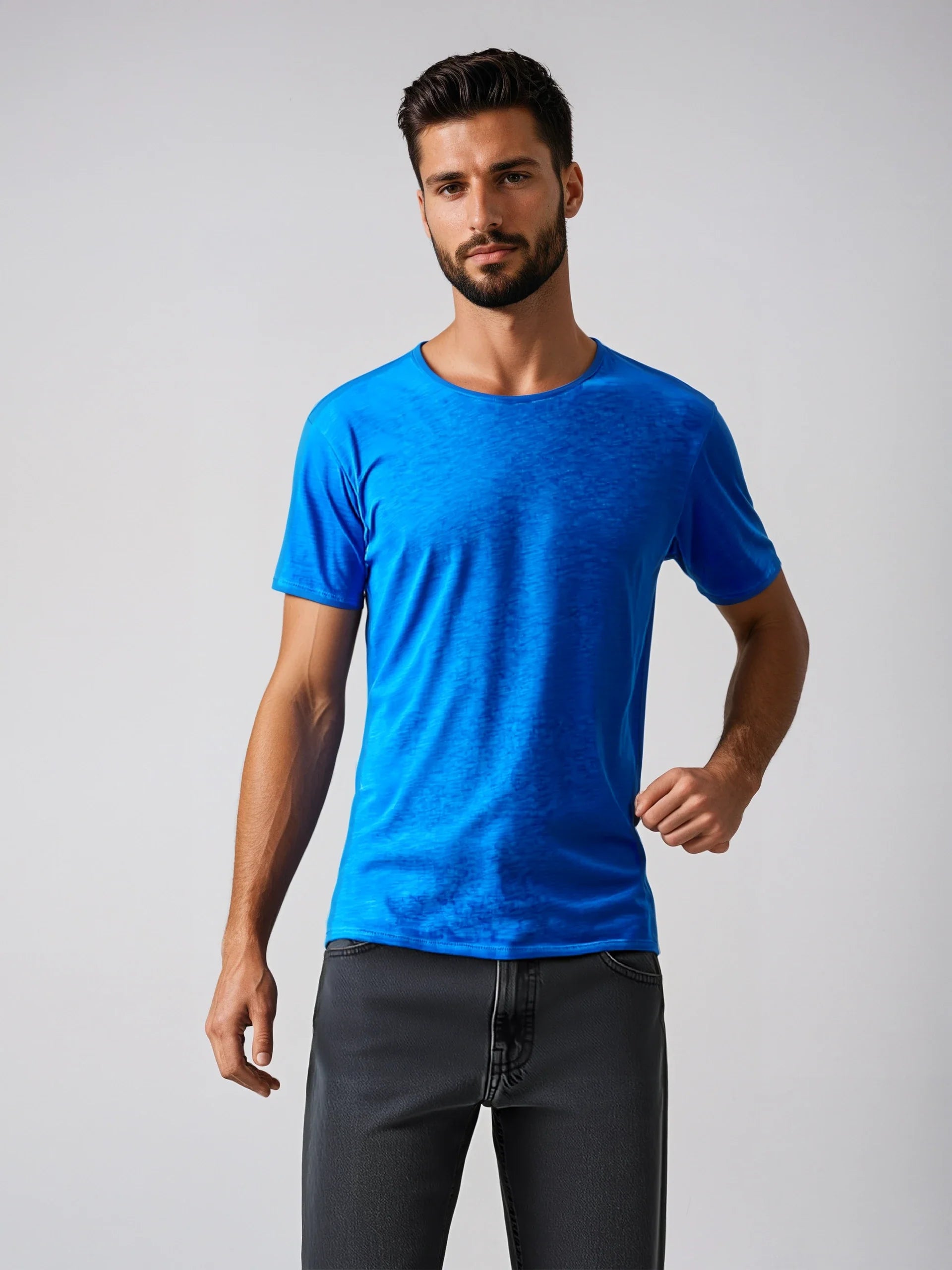 Model wearing a bright blue Short Sleeve Roll Neck T, a lightweight staple for casual and formal outfits, made in Italy.