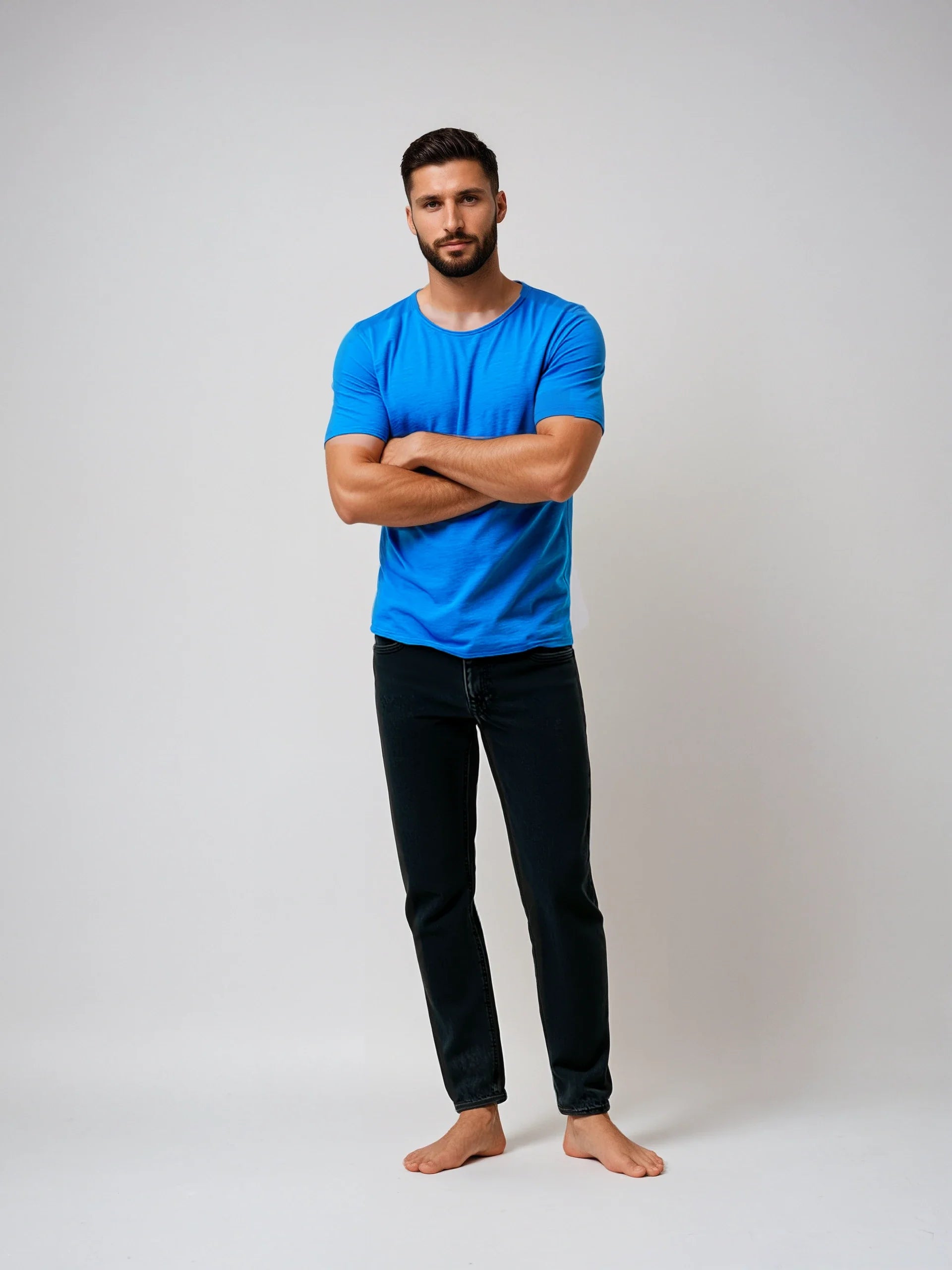 Man wearing a vibrant blue Short Sleeve Roll Neck T with jeans, showcasing a casual look.