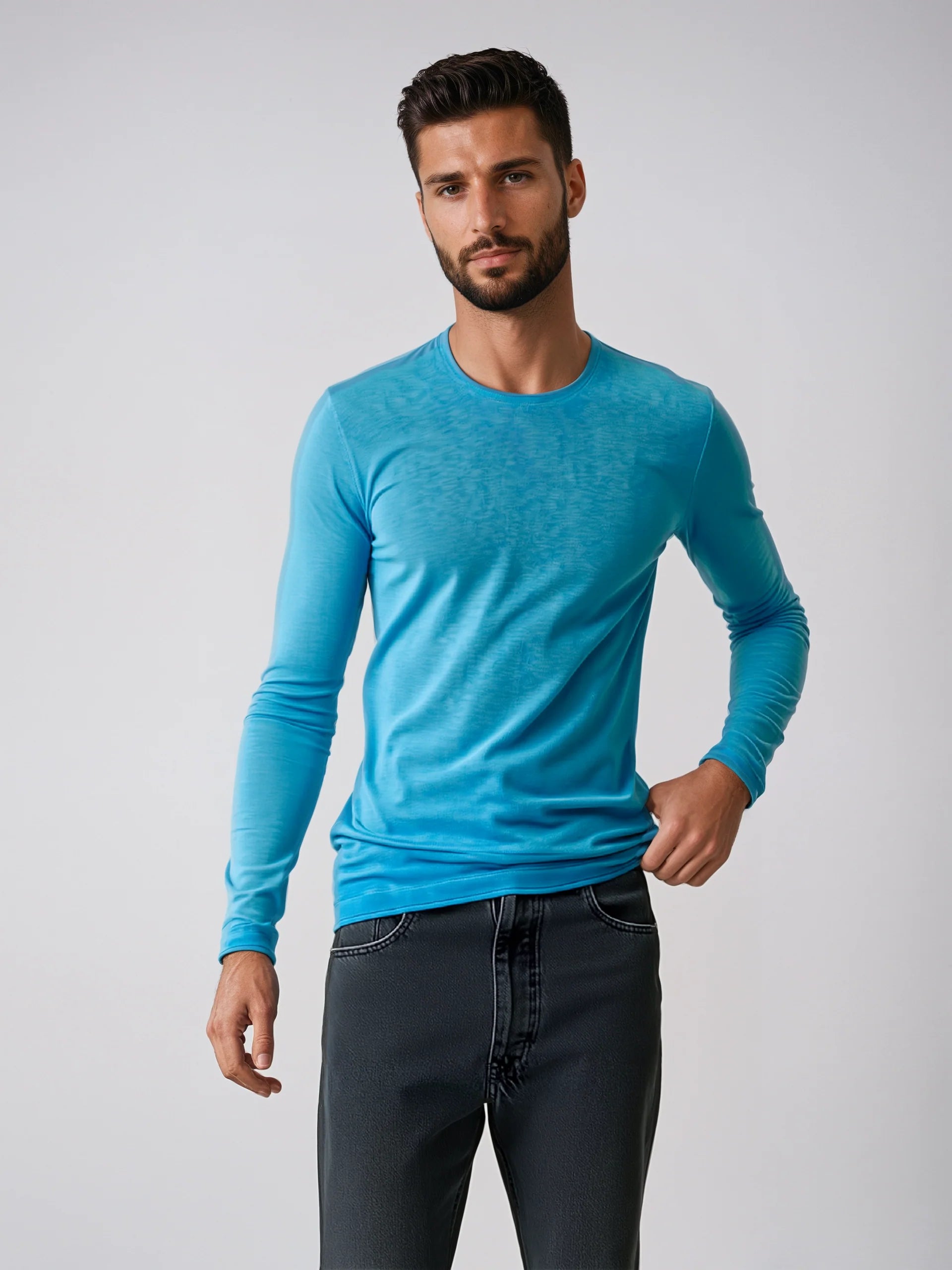Man wearing a light blue Long Sleeve Sweater, showcasing casual style and soft cotton fabric. Ideal for various occasions.