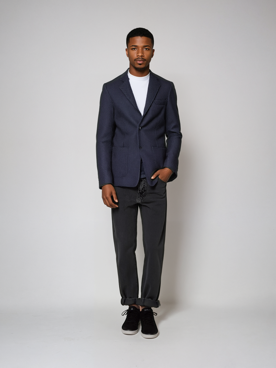 Man wearing sophisticated Pin Dot Knit Blazer with sharp details, two-button design, and floral paisley lining for elegant fit.