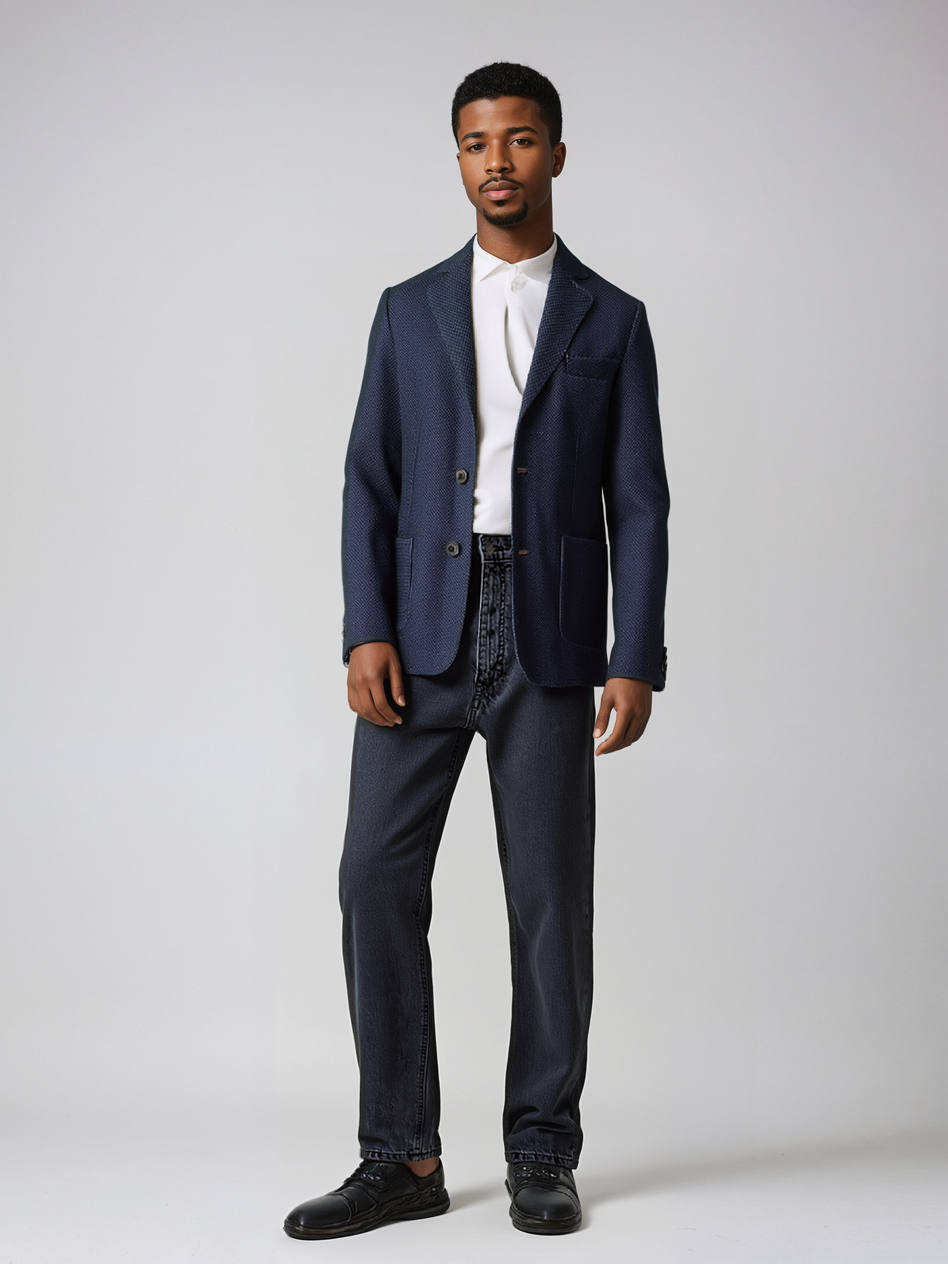 Man wearing Pin Dot Knit Blazer with two buttons, patch pockets, and floral paisley lining, paired with dark jeans and shoes.