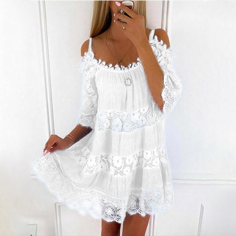 Woman wearing Lace Embrace Summer Sling Dress with lace fabric and flowing flying sleeves in white.