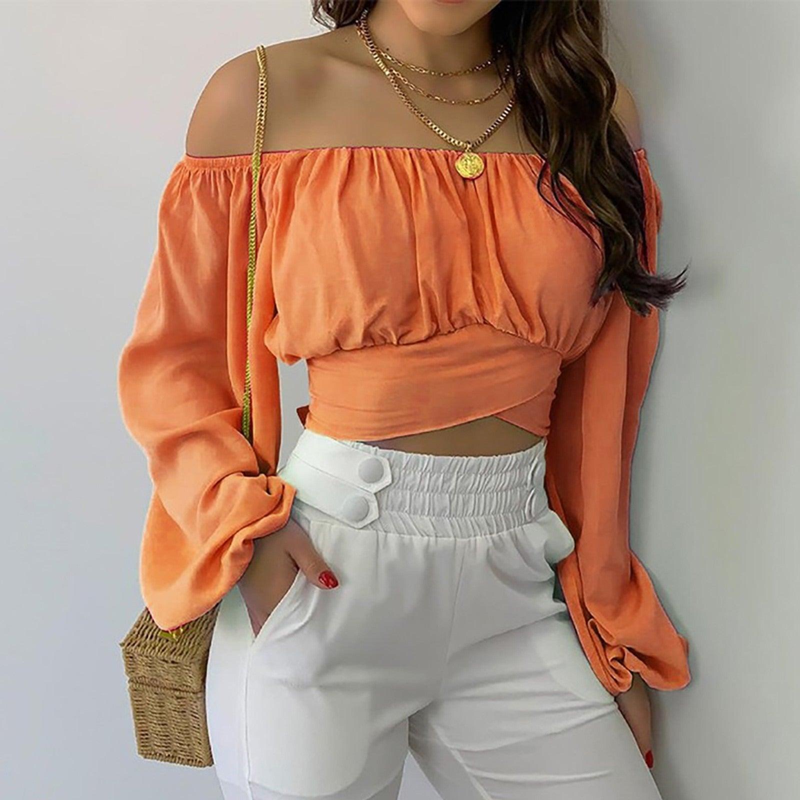 Woman wearing Off Shoulder Cross Tie Long Sleeve Top | Sexy & Trendy Cowgirl Look in vibrant orange with white pants.