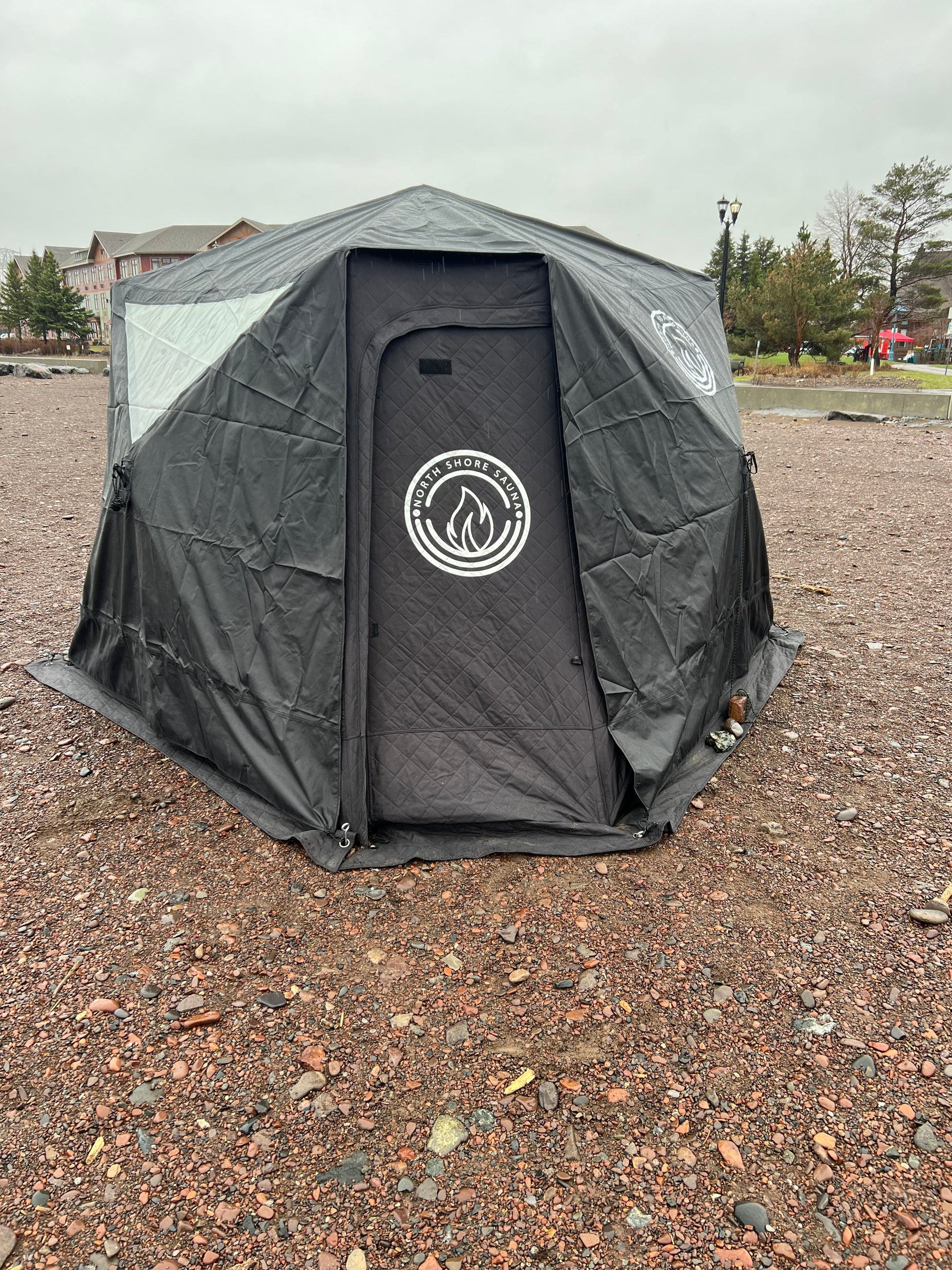 Full cover for Nova 6 Sauna Tent with window feature for visibility during use, protecting against rain while camping outdoors.