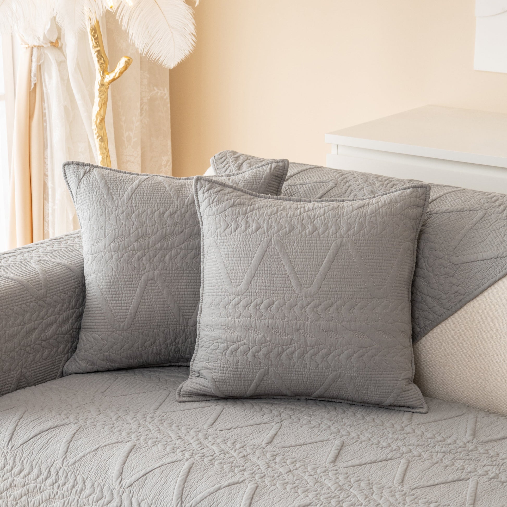 Geometric Textured Cotton Quilted Sofa Cover, Non-Slip Washable Couch Protector in gray with intricate V-shaped patterns.