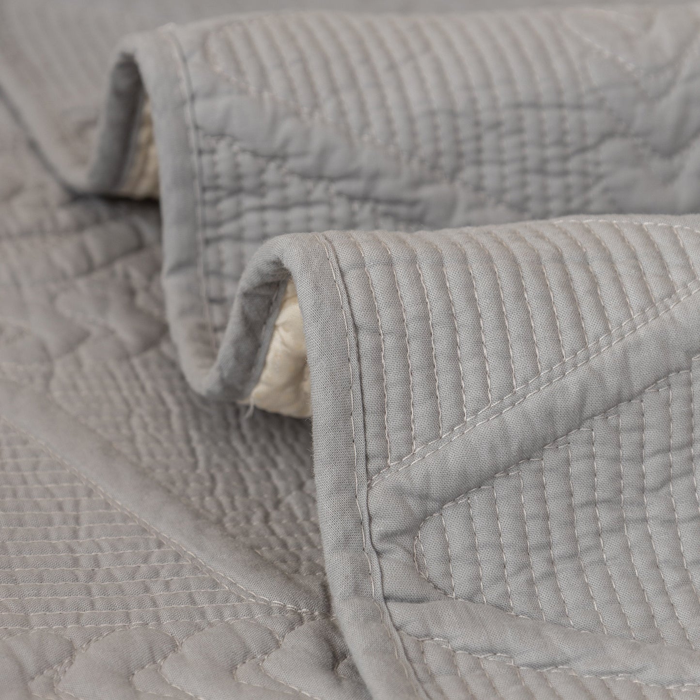 Geometric Textured Cotton Quilted Sofa Cover, Non-Slip Washable Couch Protector with intricate V-shaped stitching.