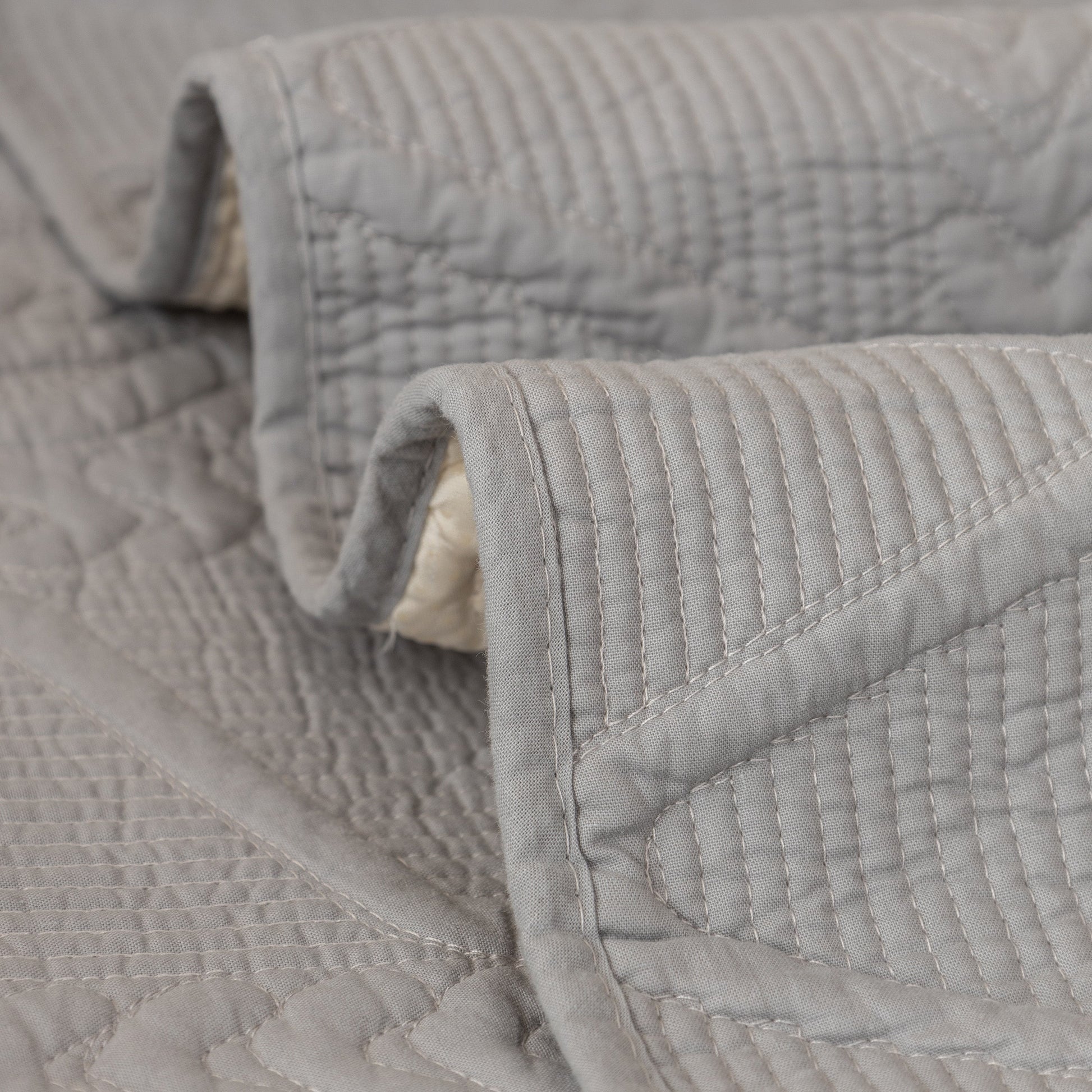 Geometric Textured Cotton Quilted Sofa Cover, Non-Slip Washable Couch Protector with intricate V-shaped stitching.