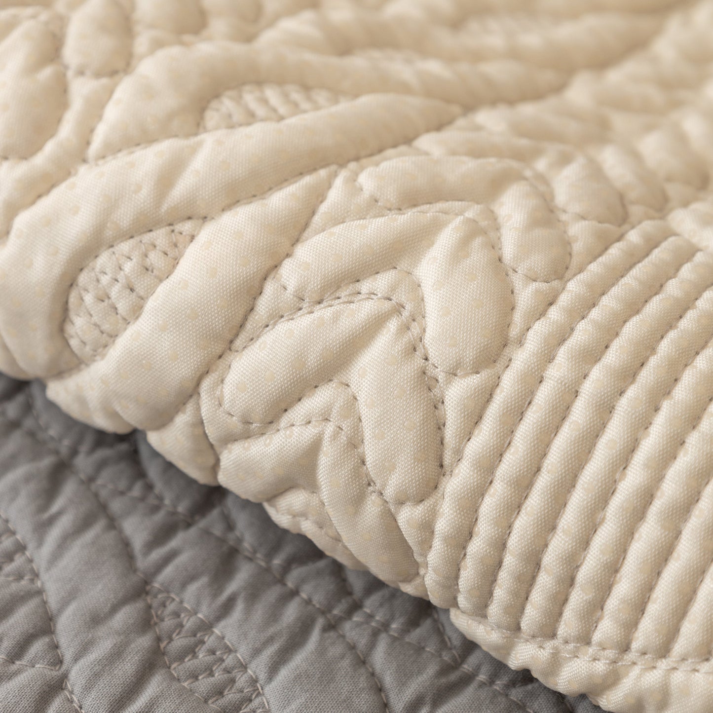 Geometric Textured Cotton Quilted Sofa Cover, Non-Slip Washable Couch Protector with V-shaped and angular stitching detail.