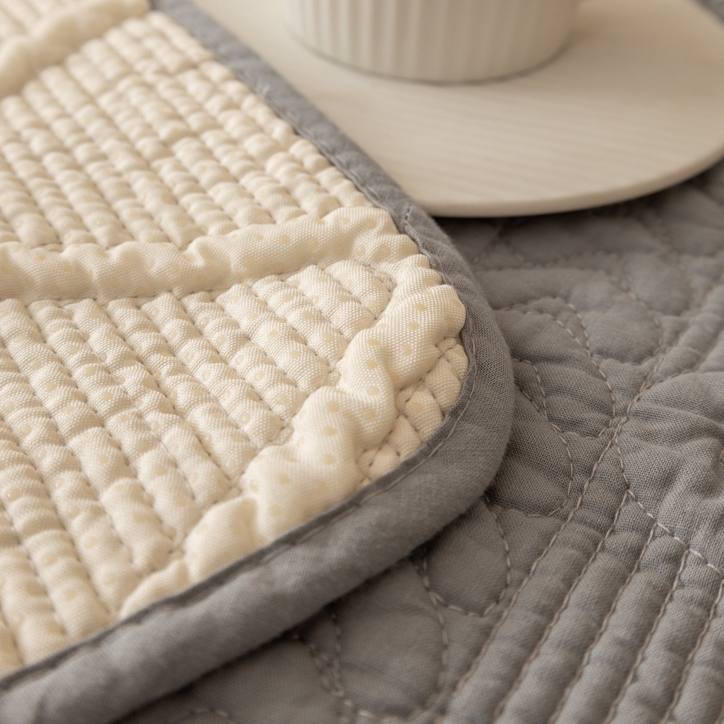 Detail of Geometric Textured Cotton Quilted Sofa Cover, Non-Slip Washable Couch Protector with intricate stitching