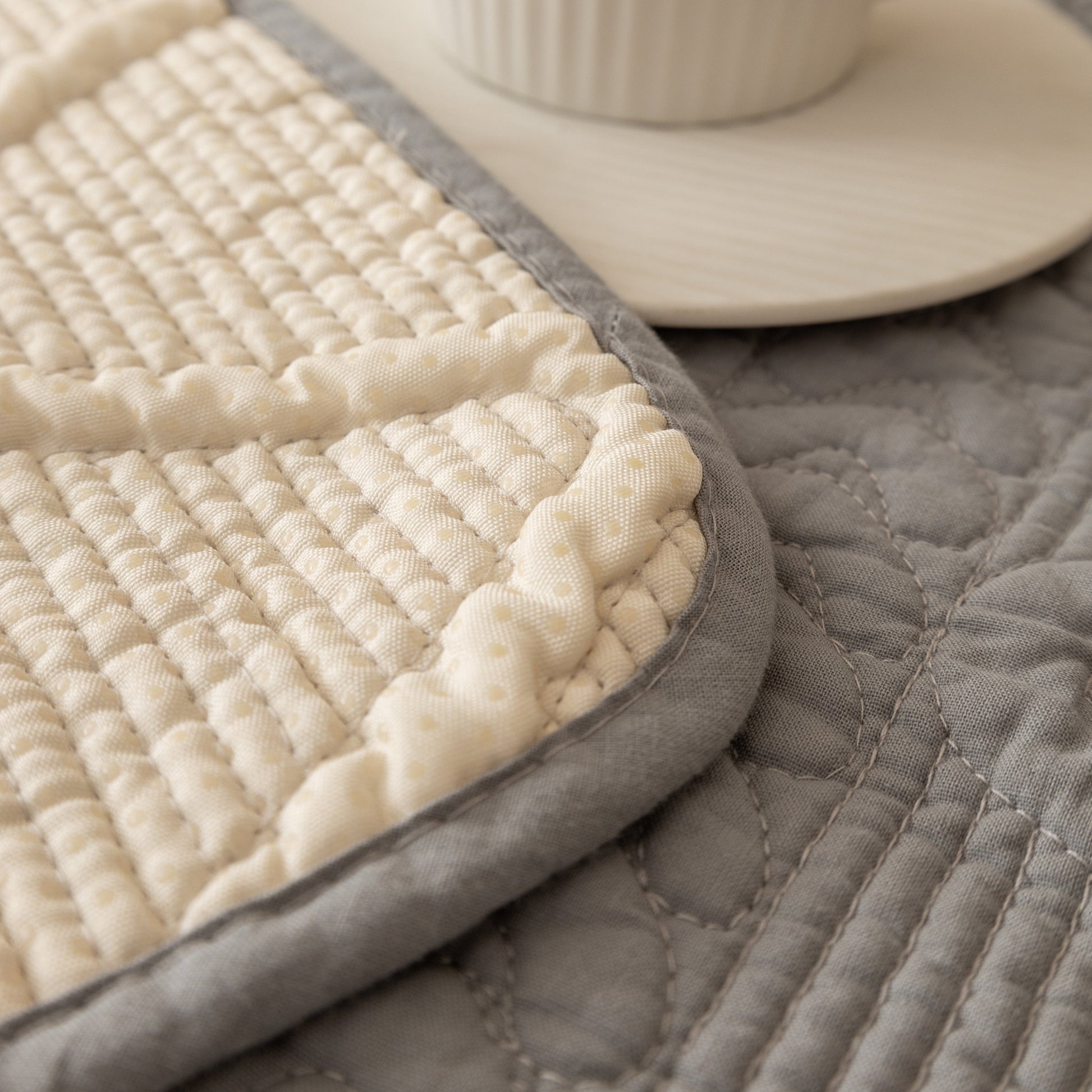 Detail of Geometric Textured Cotton Quilted Sofa Cover, Non-Slip Washable Couch Protector with intricate stitching
