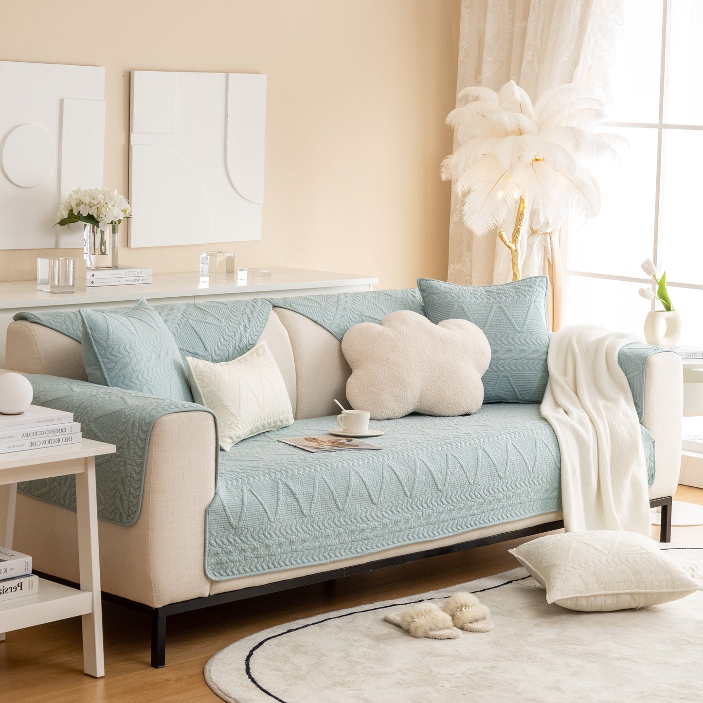 Light blue Geometric Textured Cotton Quilted Sofa Cover, Non-Slip Washable Couch Protector on a modern beige sofa in a chic living room.