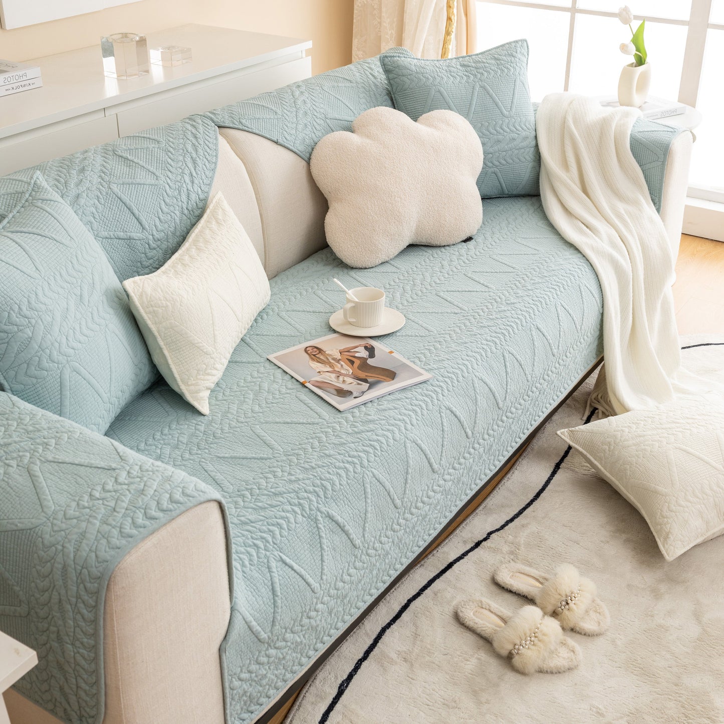 Living room with blue Geometric Textured Cotton Quilted Sofa Cover, Non-Slip Washable Couch Protector and cloud pillow.