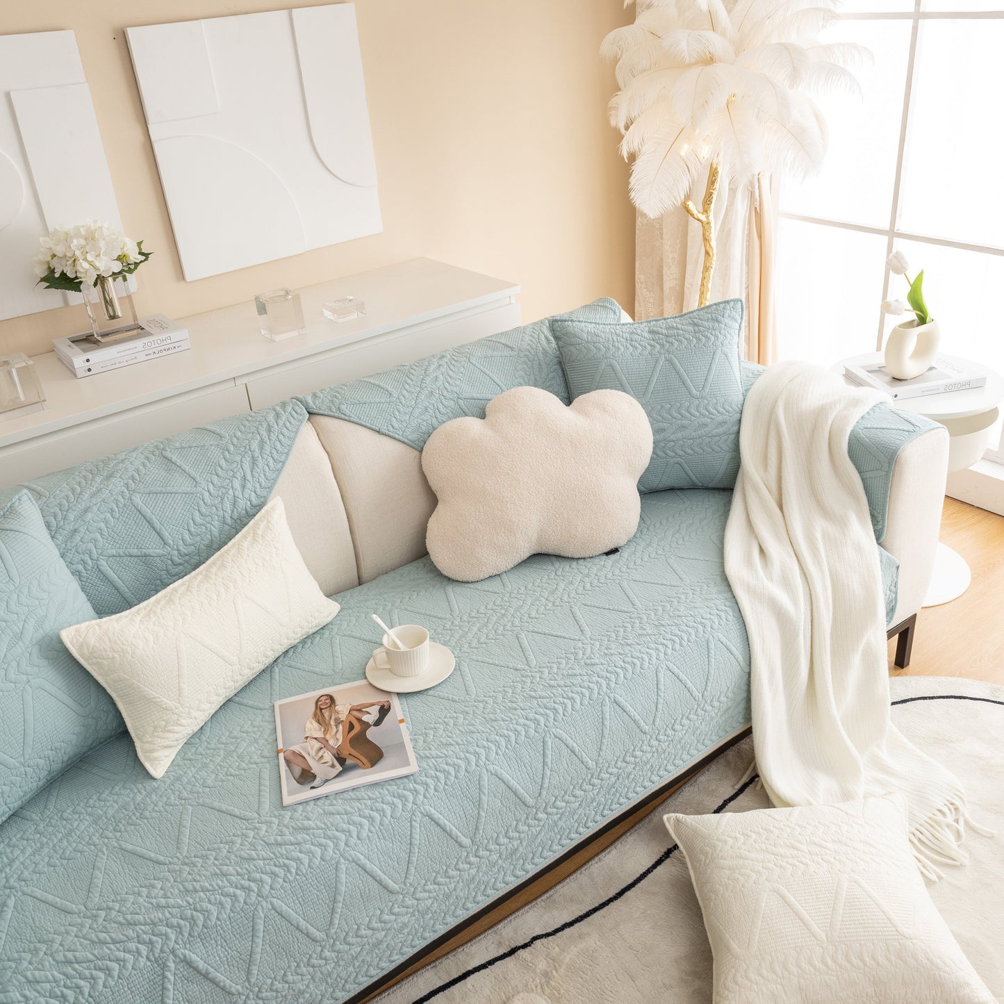Modern living room with Geometric Textured Cotton Quilted Sofa Cover, Non-Slip Washable Couch Protector in blue, featuring pillows.
