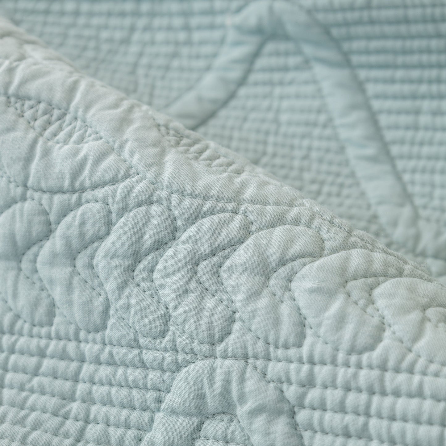 Close-up of Geometric Textured Cotton Quilted Sofa Cover, Non-Slip Washable Couch Protector with intricate stitching.