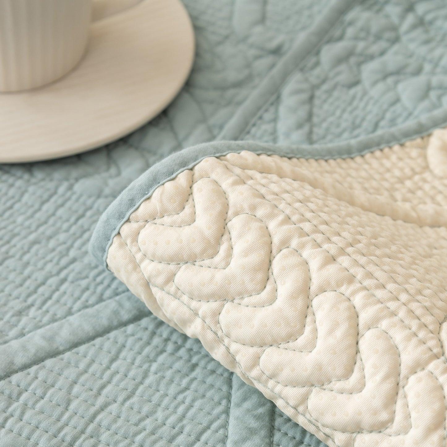 Geometric Textured Cotton Quilted Sofa Cover, Non-Slip Washable Couch Protector in blue with intricate stitching pattern