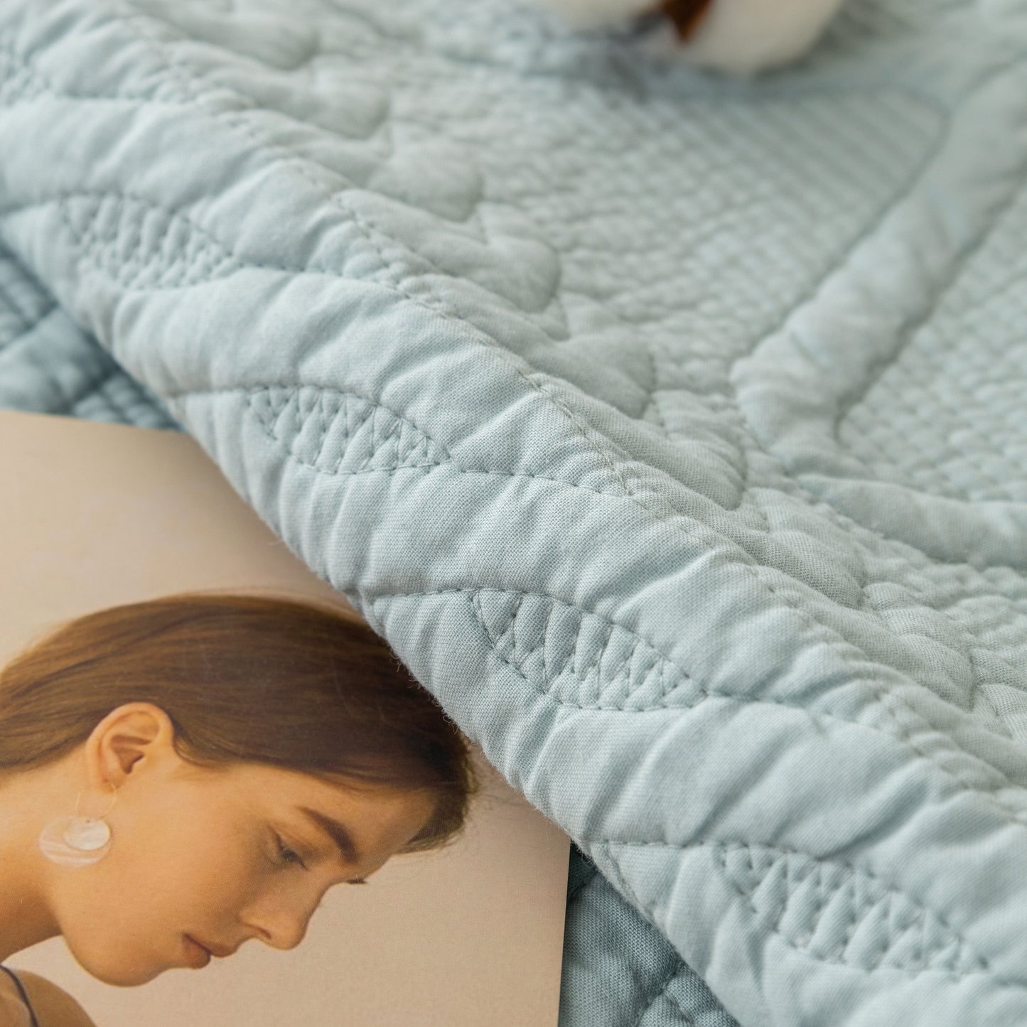 Close-up of Geometric Textured Cotton Quilted Sofa Cover, Non-Slip Washable Couch Protector with intricate stitching.