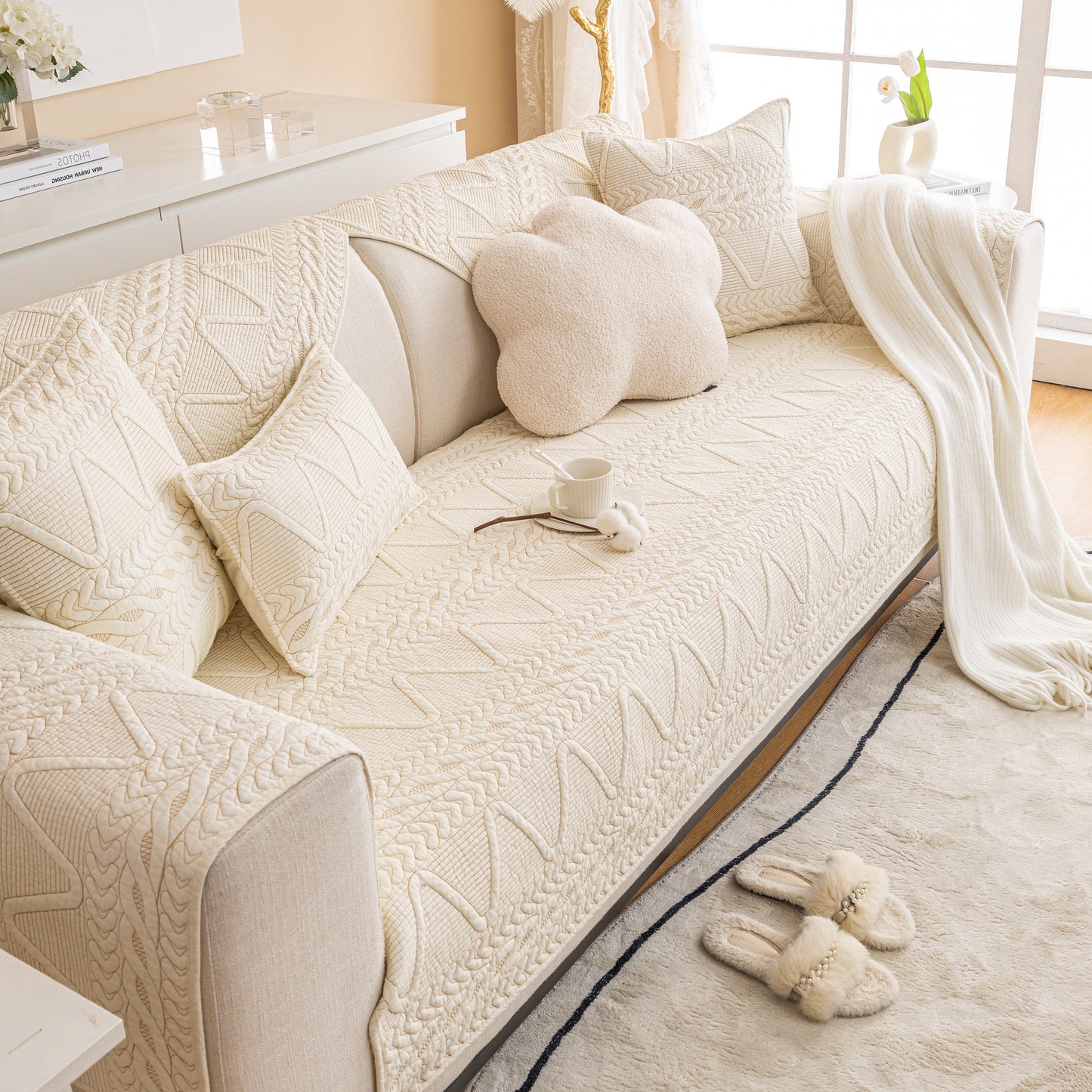 Geometric Textured Cotton Quilted Sofa Cover, Non-Slip Washable Couch Protector displayed on a modern beige sofa in a cozy living room.