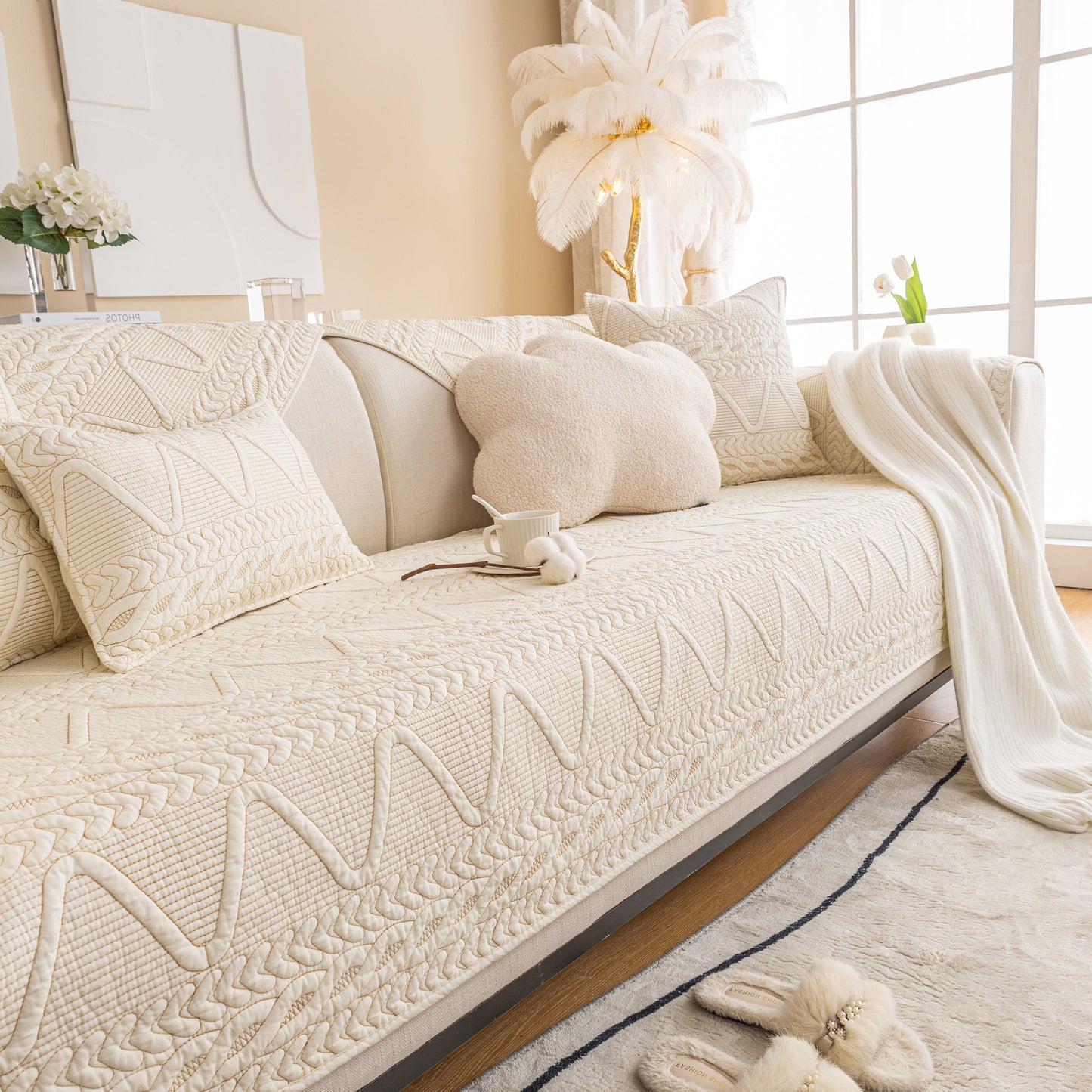 Stylish sofa adorned with Geometric Textured Cotton Quilted Sofa Cover, Non-Slip Washable Couch Protector in cozy living room.