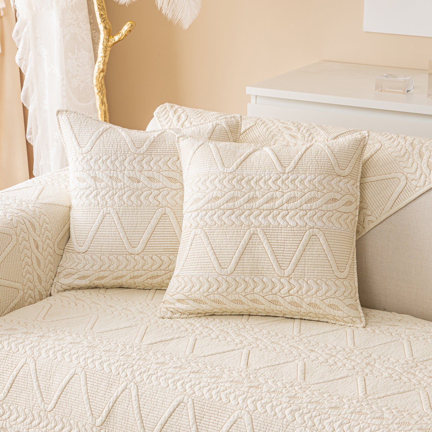 Geometric Textured Cotton Quilted Sofa Cover, Non-Slip Washable Couch Protector with V-shaped motifs on a cream sofa