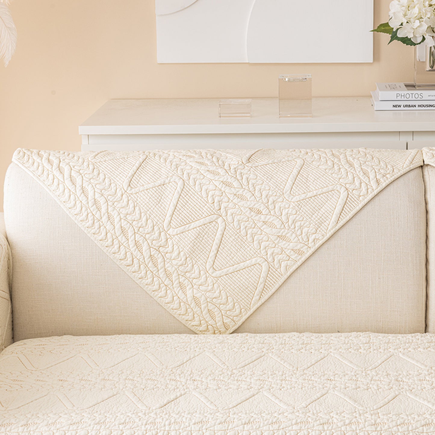 Geometric Textured Cotton Quilted Sofa Cover, Non-Slip Washable Couch Protector with sculptural modern design on beige sofa.