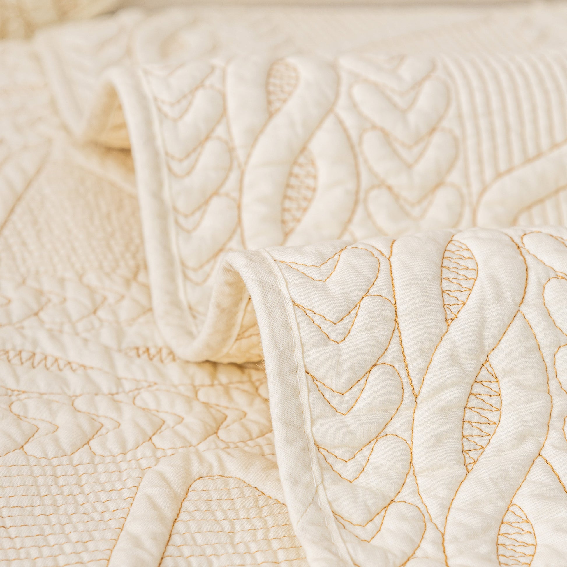 Close-up of Geometric Textured Cotton Quilted Sofa Cover, Non-Slip Washable Couch Protector with V-shaped motifs.