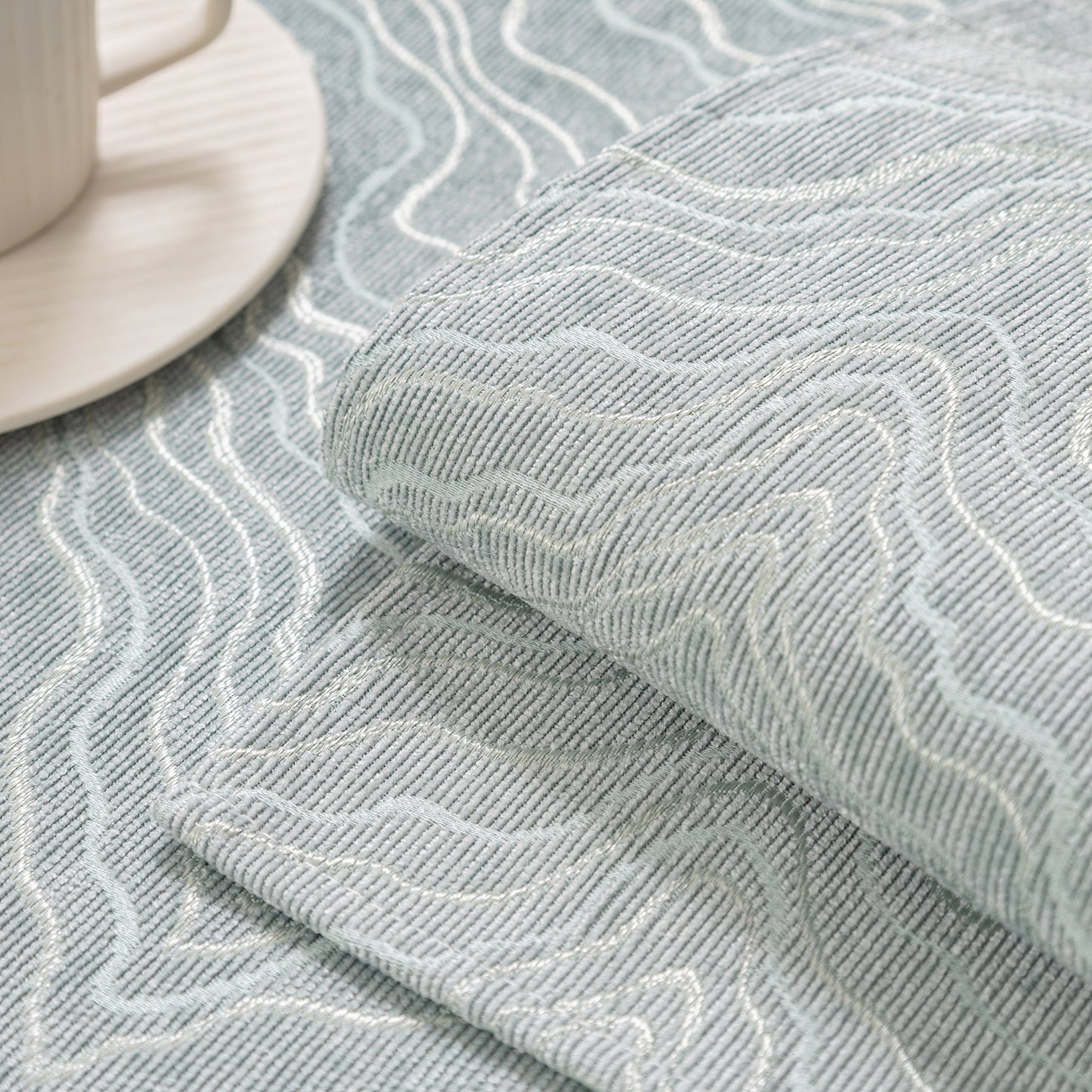 Close-up of modular sofa cover fabric showing wave pattern texture, featuring gold striped non-slip design for sectionals and couches.